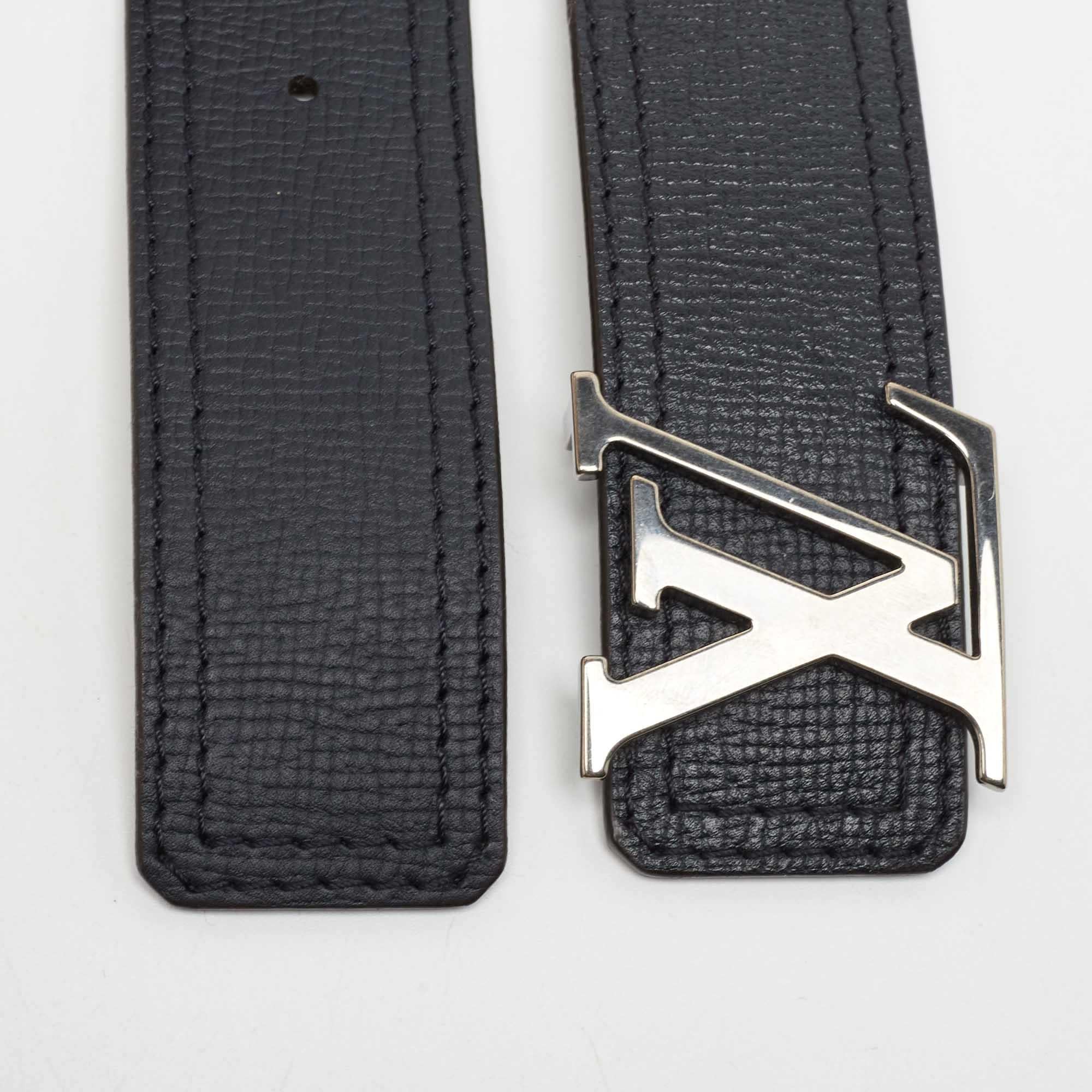 Experience the high-functionality and fine quality of luxurious accessories as you wear this belt designed by Louis Vuitton. It is crafted with black leather and showcases the LV Initiales logo on the buckle.

Includes: Original Dustbag

