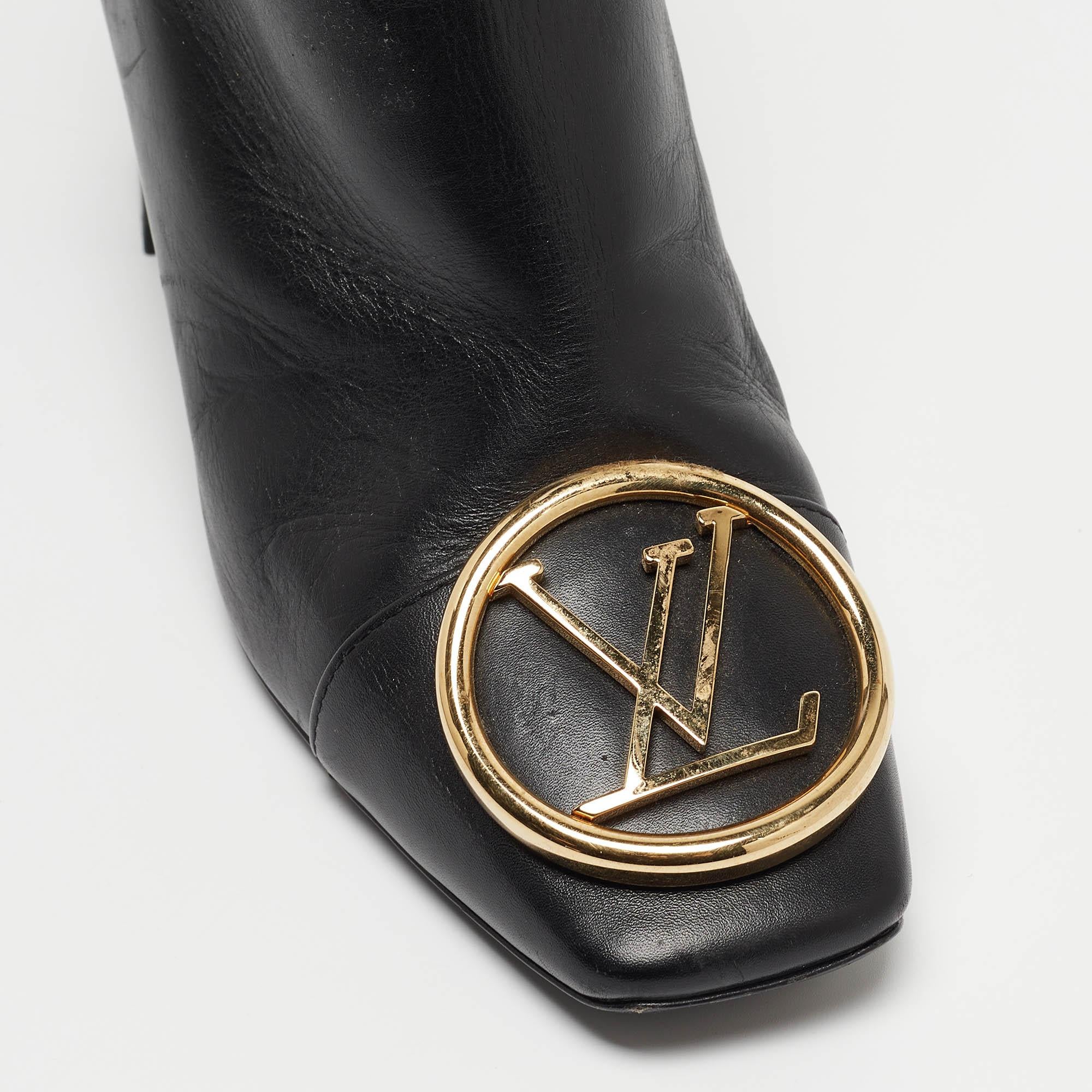 Crafted from supple black leather, Louis Vuitton's Madeleine ankle boots epitomize elegance. With a sleek silhouette and a sturdy block heel, they exude timeless style. The iconic LV monogram subtly adorns the front, adding a touch of luxury to any
