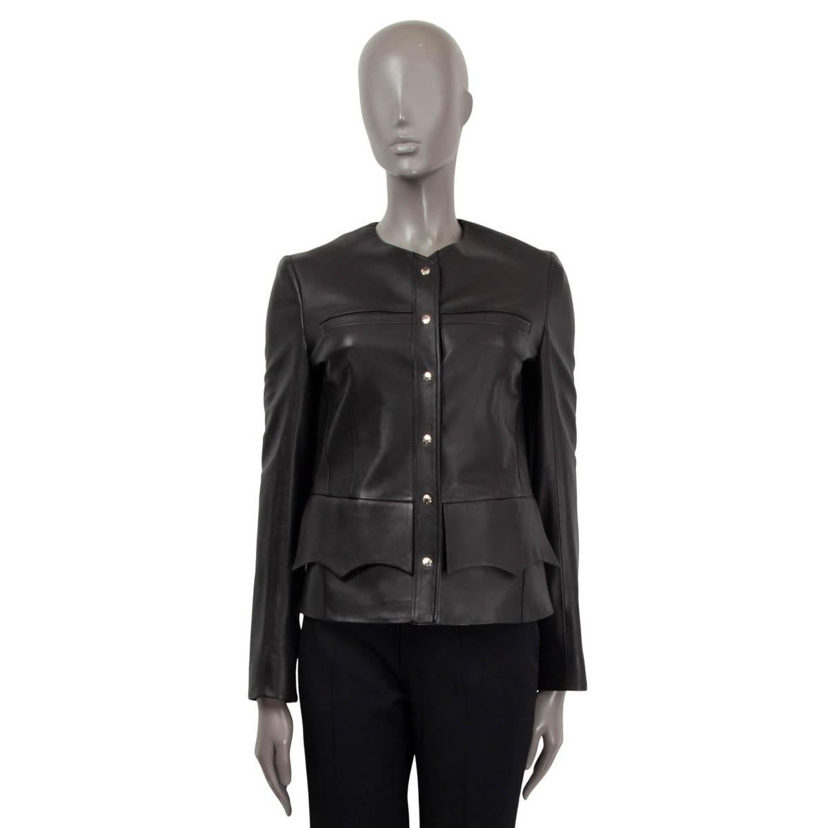 100% authentic Louis Vuitton long sleeve blazer in black soft lamb leather (100%). Features two slit pockets on the chest and two scalloped flap pockets. Opens with silver-tone 'Louis Vuitton' push buttons on the front. Lined in black viscose (50%)