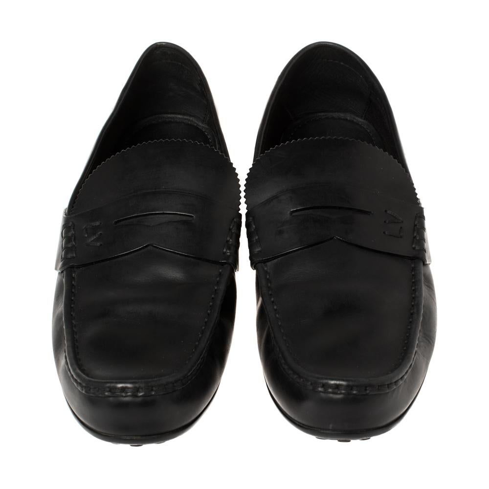 Look sharp and neat with this pair of loafers from Louis Vuitton. They have been crafted from black leather and designed with the brand label-stitched strap on the uppers. The pair is complete with comfortable insoles and rubber soles.

