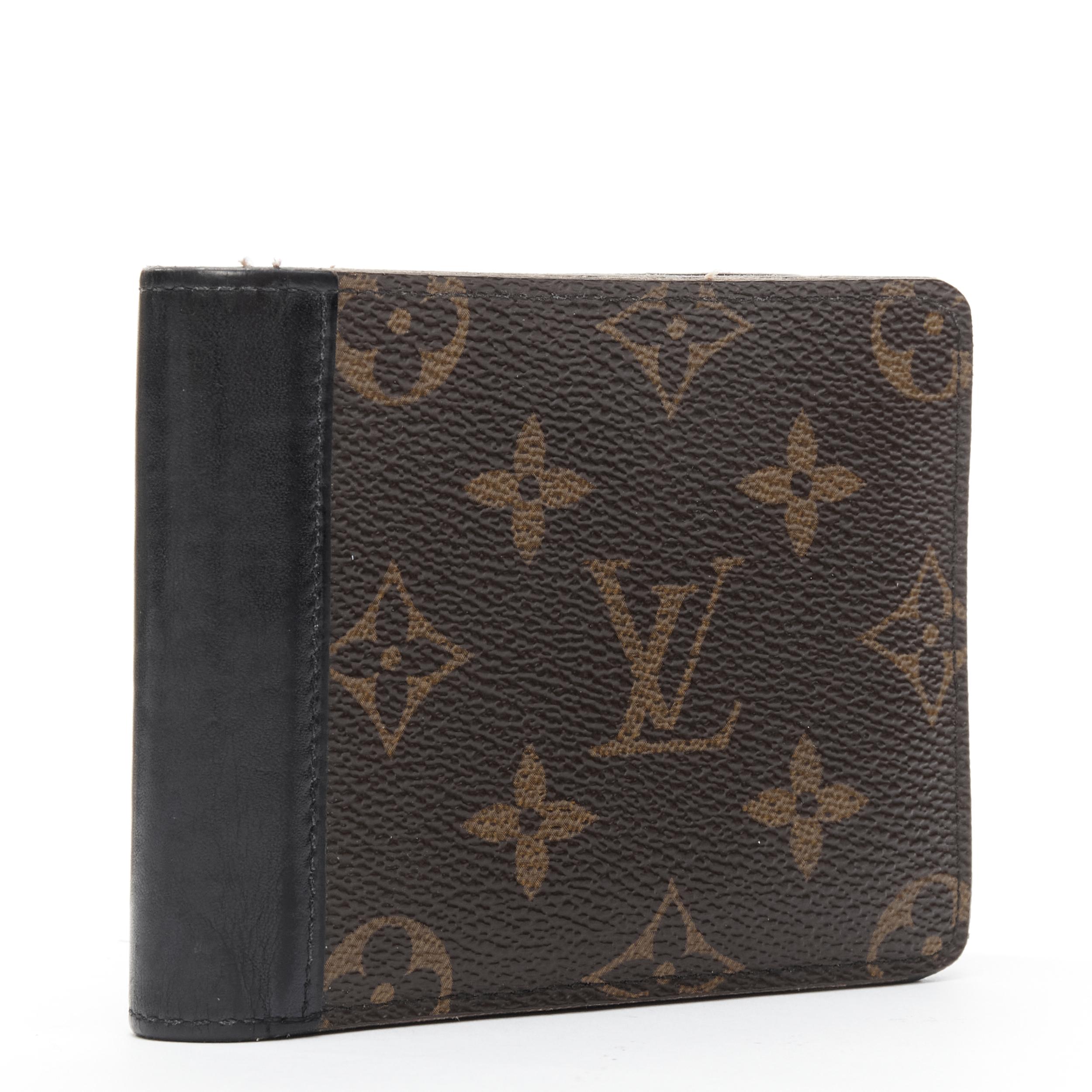 LOUIS VUITTON black leather spine brown LV monogram canvas bifold wallet 
Reference: TALI/A00005 
Brand: Louis Vuitton 
Material: Canvas 
Color: Brown 
Pattern: Abstract 
Extra Detail: Bifold wallet. Brown monogram canvas. Black leather trimming.