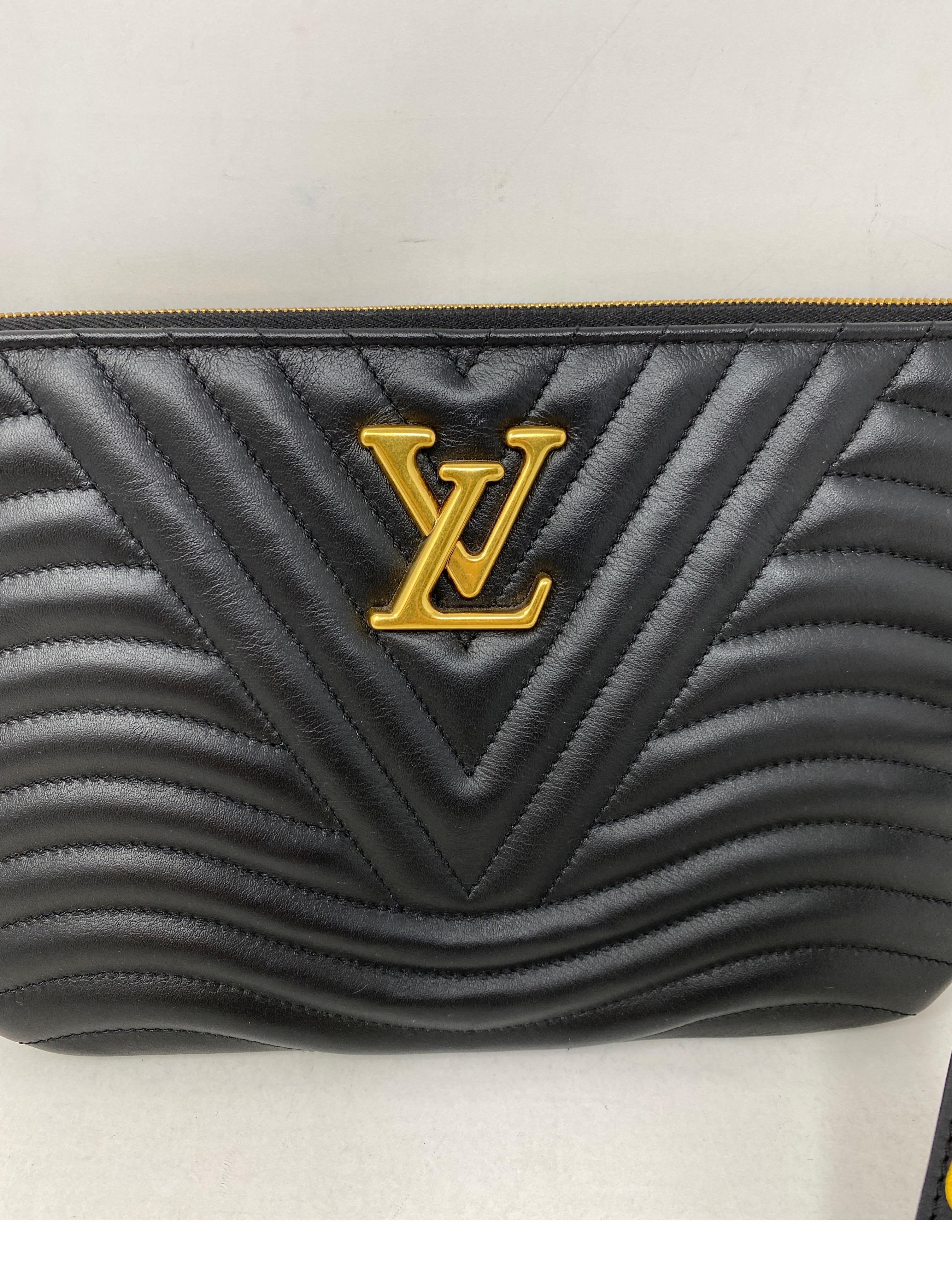 Louis Vuitton Black Leather Wave Pouch. Brand new condition. Never used. Can be worn as a wristlet or a clutch. Guaranteed authentic. 