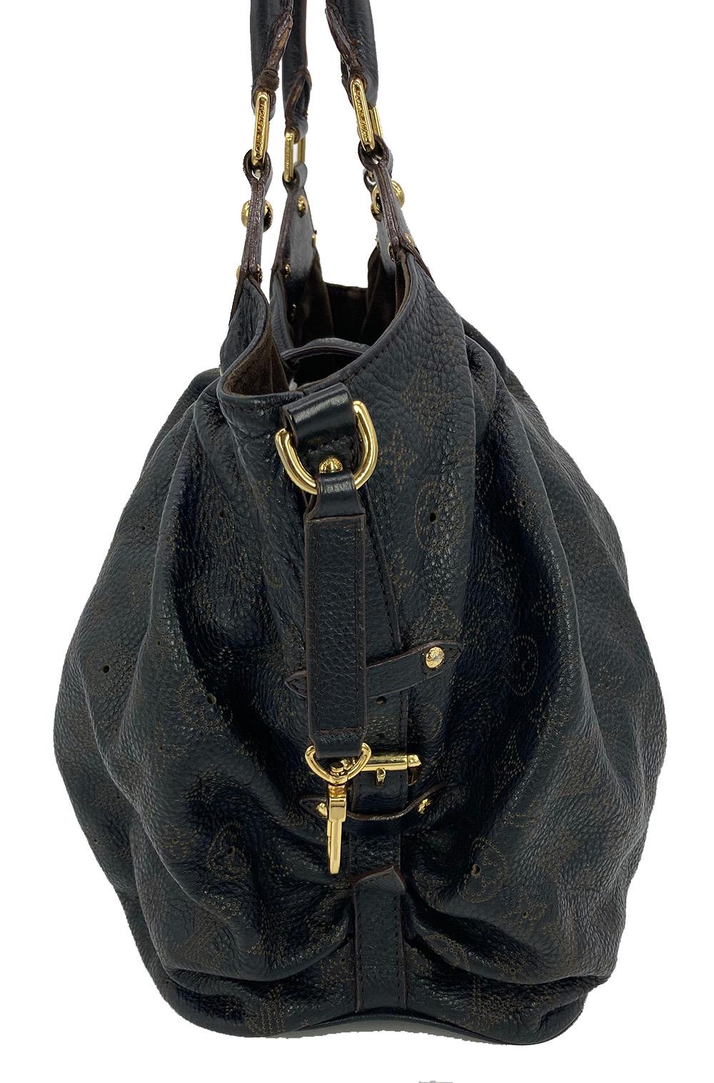 Louis Vuitton Black Mahina GM Shoulder Bag in very good condition. Pleated Black mahina leather exterior with perforated monogram design trimmed with gold hardware and double top handles. Top sliding latch strap closure opens to a brown suede