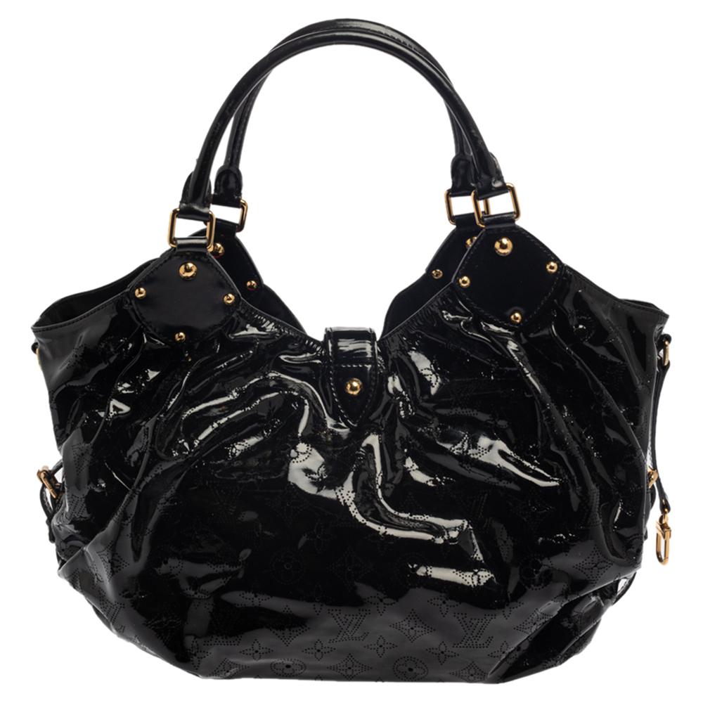 This Louis Vuitton bag is designed exquisitely. Its glossy, black leather body is inspired by the Hindu Sun God, Surya. Feminine and chic, this slouchy bag is roomy and perfect for everyday use. Crafted from intricate perforated LV monogram patent
