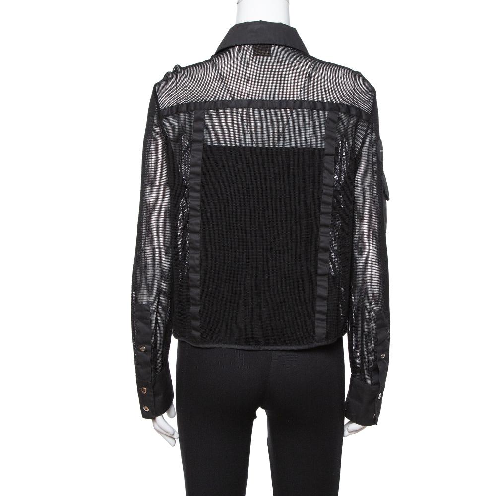 Express your subtle style with this black shirt from Louis Vuitton. It is made from cotton mesh featuring long sleeves, trims and pockets on the front as well as on the long sleeve. A pair of shorts and loafers will complement this shirt on any