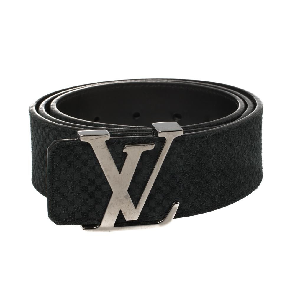 This Initiales belt from Louis Vuitton is simple in design but nevertheless quite appealing. The black suede belt flaunts the signature mini Damier pattern and has a silver-tone buckle in the form of an enlarged LV symbol. The belt is perfect for