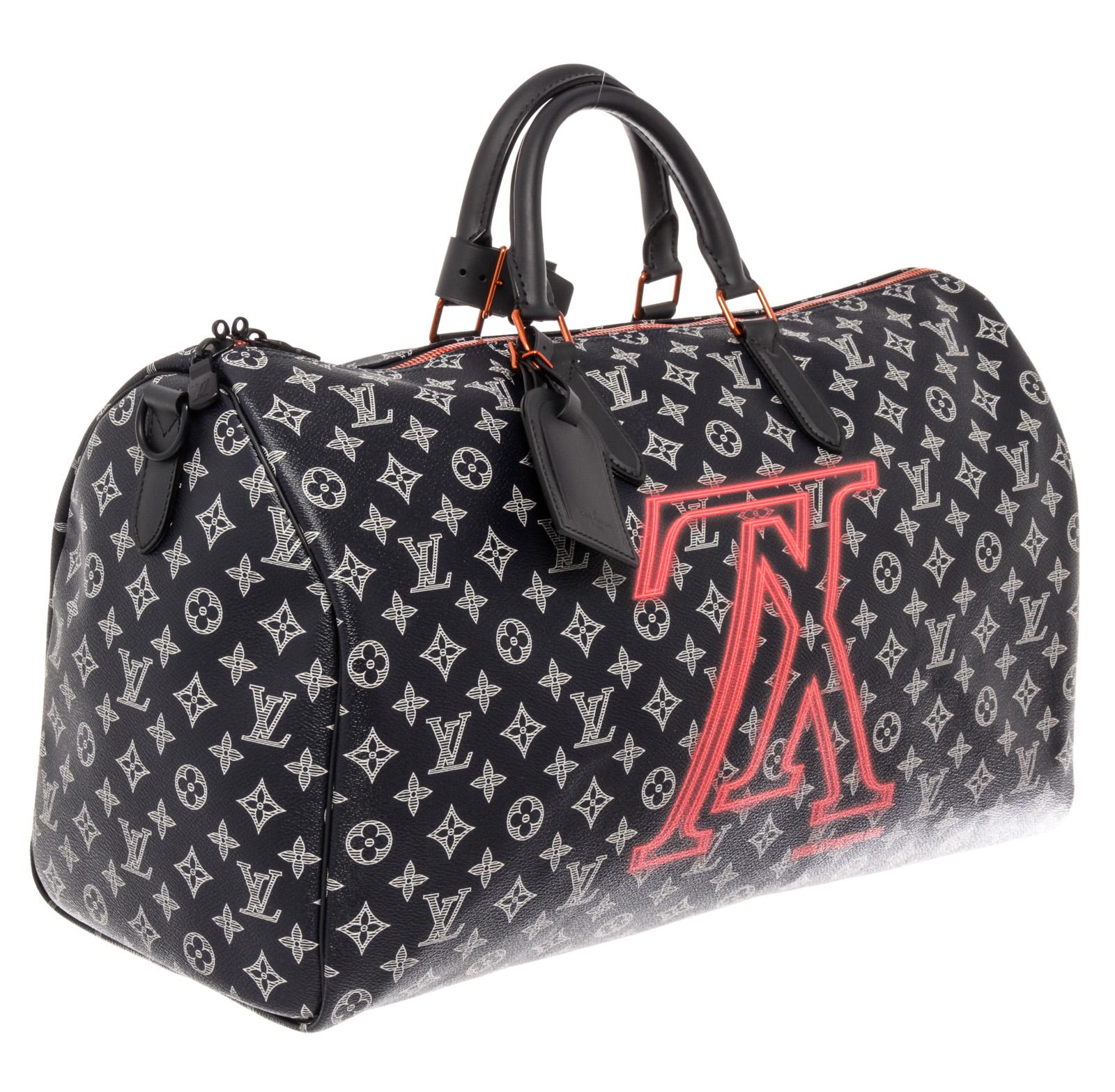 Men's midnight and white Monogram coated canvas Louis Vuitton Upside Down Keepall Bandouliere 50 weekender with multitonal hardware, dual rolled top handles, single flat adjustable canvas shoulder strap, tonal leather trim, inverted Initiales print