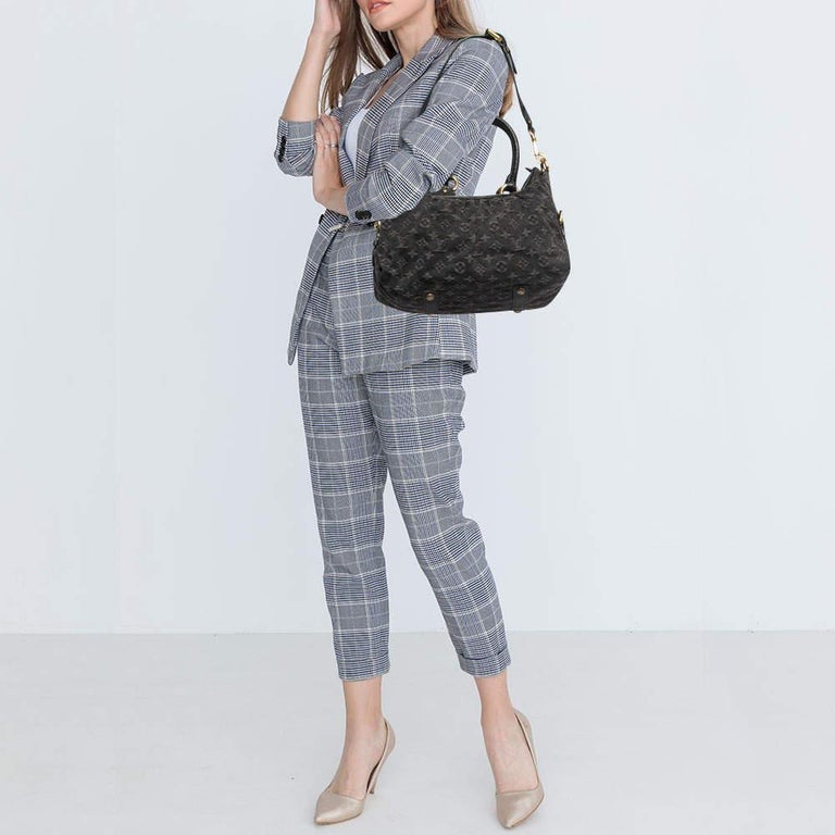 Louis Vuitton's handbags are high on style and craftsmanship, making them valuable creations of luxury. This Neo Cabby bag, like all the other handbags, is durable and stylish. Crafted from black Monogram denim and leather, the bag comes with two