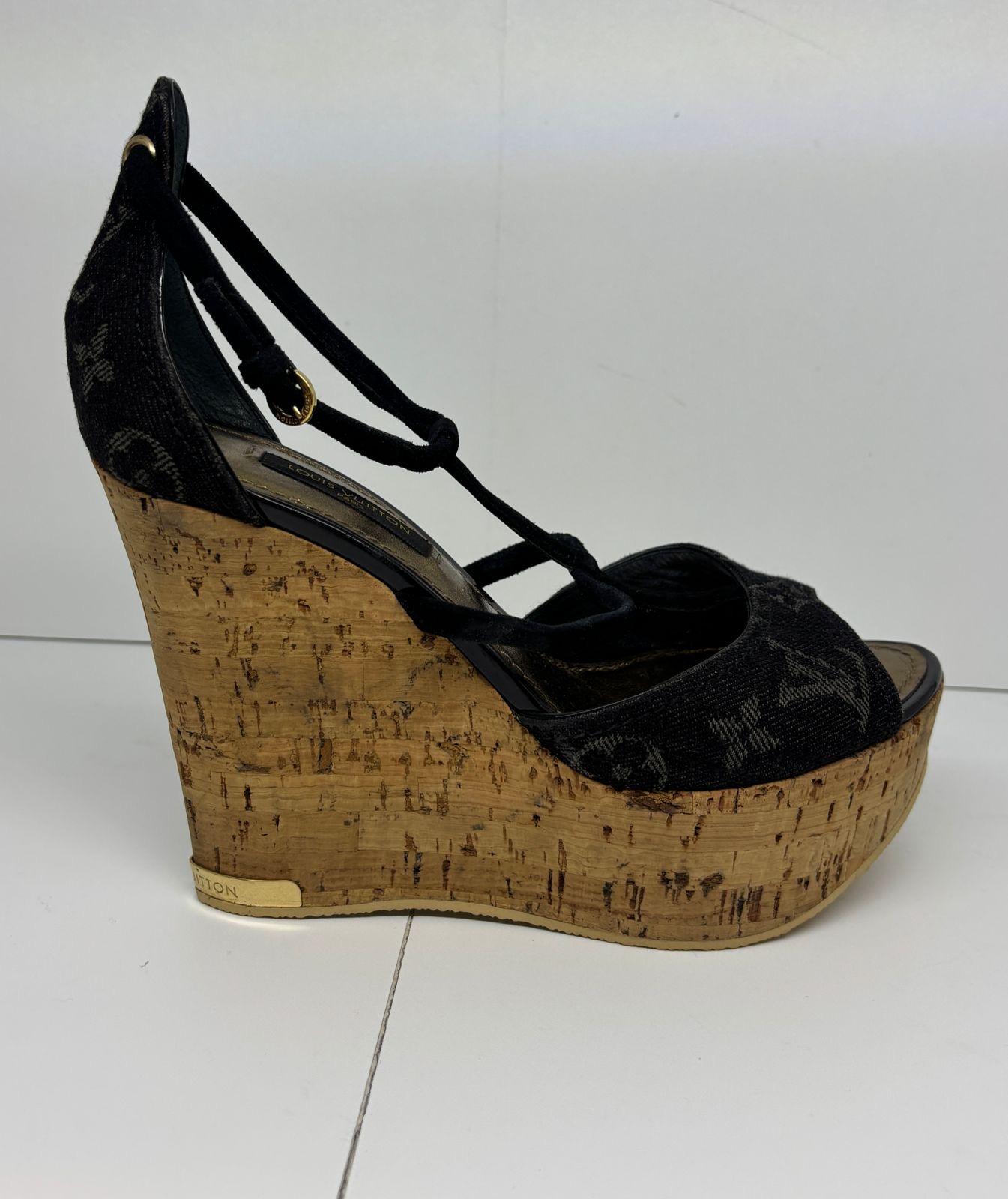 Louis Vuitton black denim monogram wedge sandals. In rarely worn condition, but shows signs of storage. Slight dryness to the strap. The bottom soles has just been replaced (same color soles) since the old ones has been kept unworn and might crack