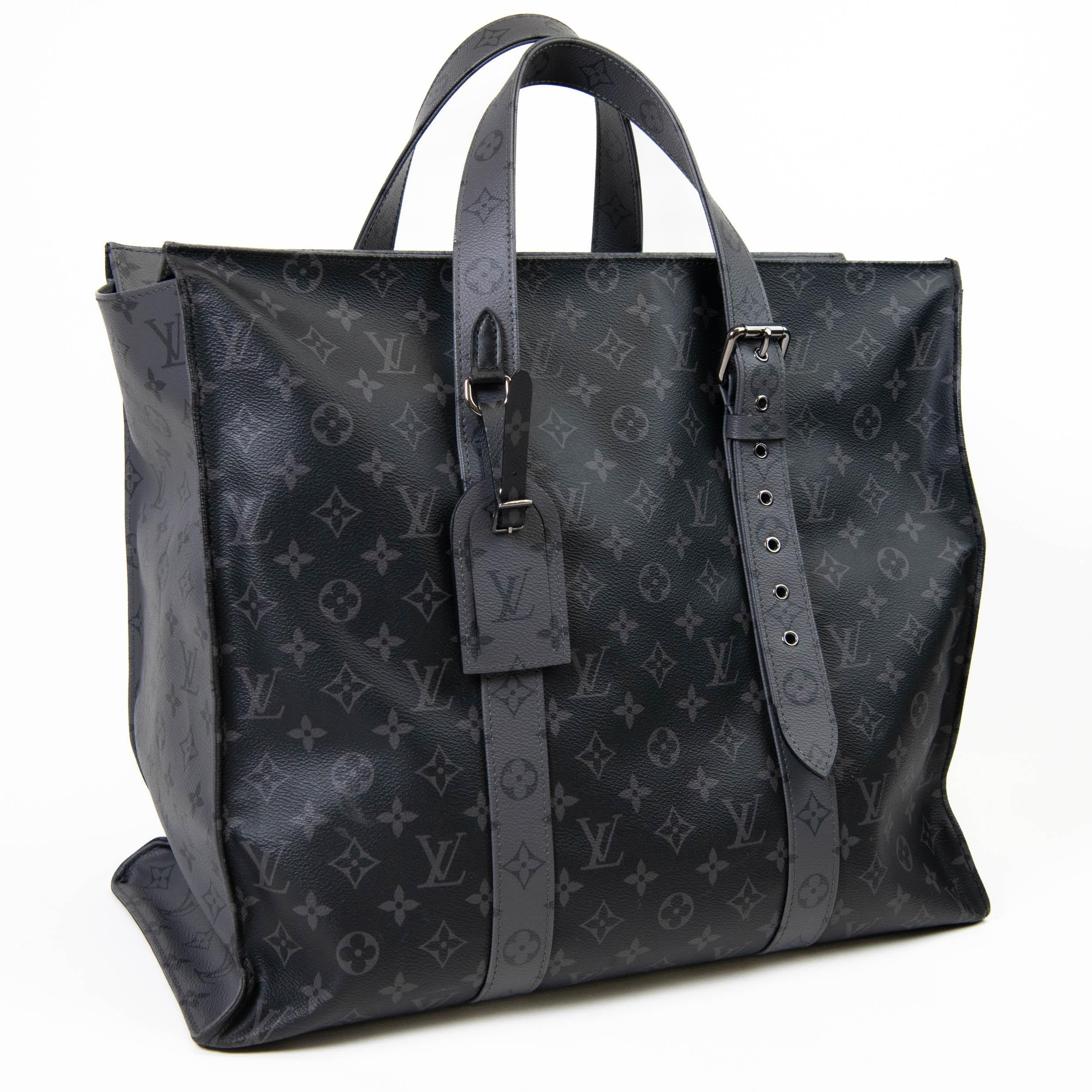 100% Authentic 

This handbag is crafted of signature Louis Vuitton monogram and reverse monogram on coated canvas in black and grey. The tote features an adjustable shoulder strap and silver hardware. The polished dark silver top zipper opens to a