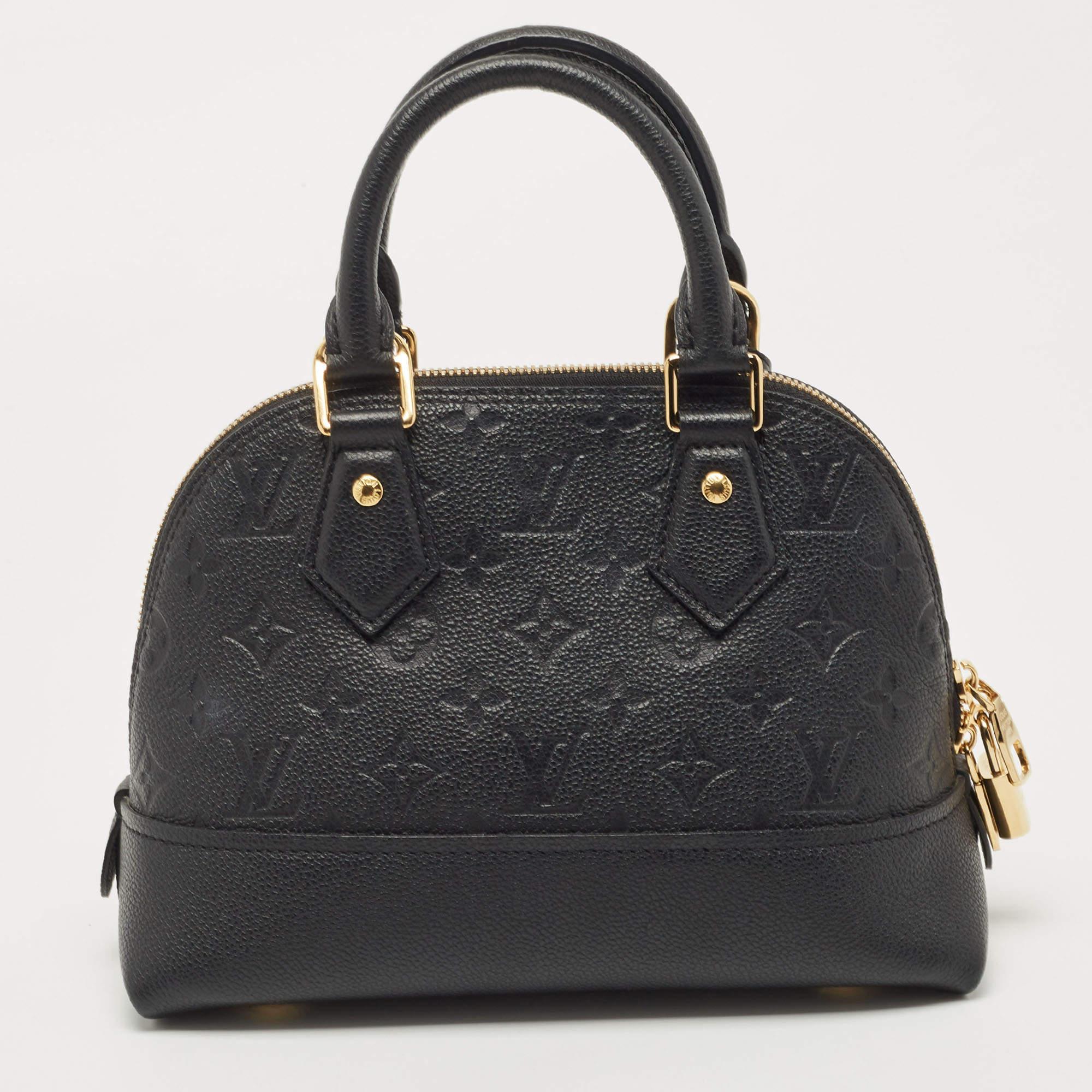 The Louis Vuitton BB Neo Alma bag is an exquisite accessory crafted from luxurious black Monogram Empreinte leather. It features a structured silhouette with signature LV embossing, dual rolled handles, a removable shoulder strap, and a top zip