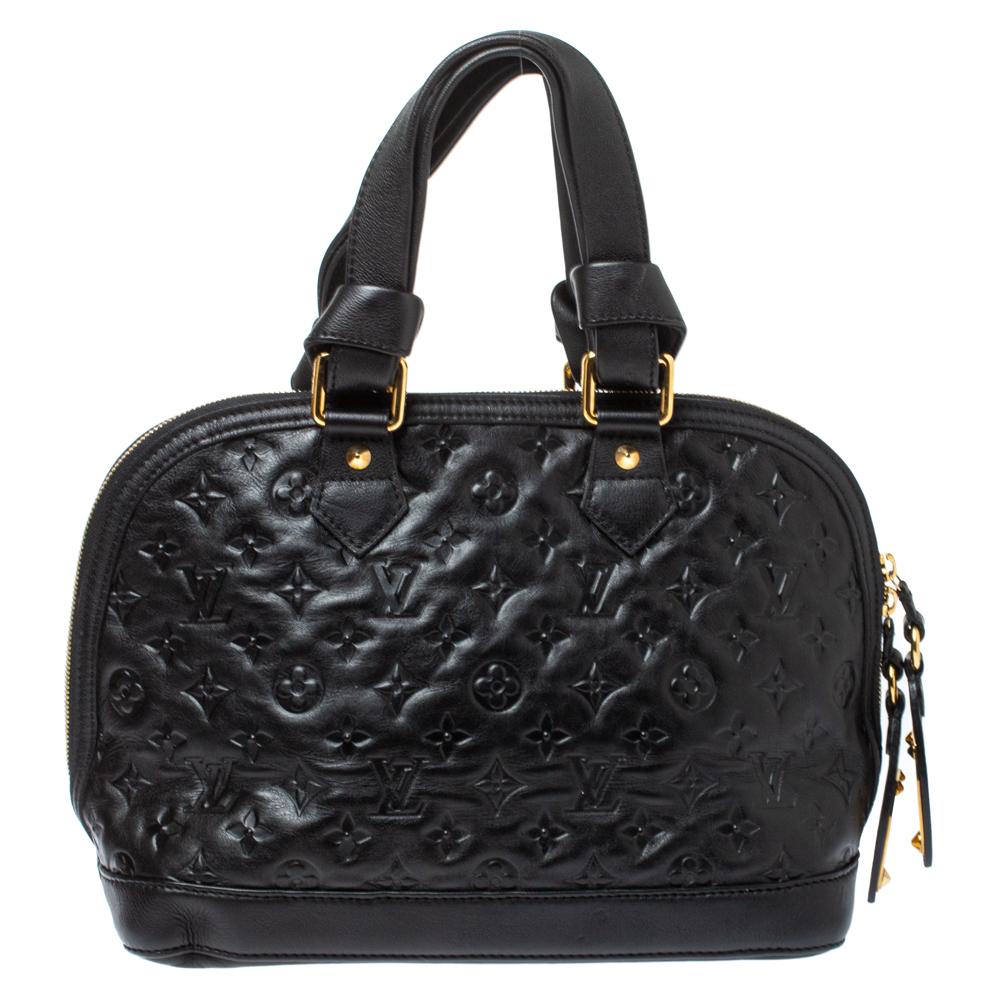 This Double Jeu Neo Alma handbag from Louis Vuitton will certainly turn heads. The stunning exterior is crafted from black Monogram Empreinte leather, that is accented with polished gold-tone hardware and stud details. Its open fabric-lined interior