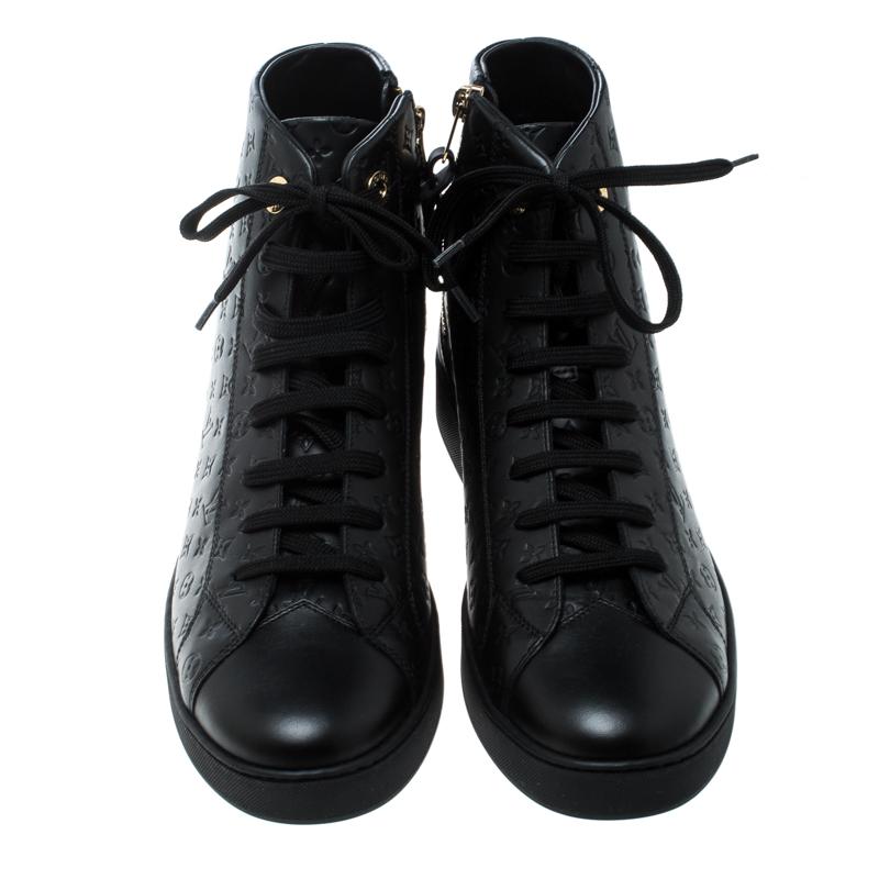 These Punchy high top sneakers from Louis Vuitton are perfect for the smart, suave and stylish women. Crafted from the brand's signature monogram Empreinte leather, these black sneakers feature round toes, lace-ups on the vamps and gold-tone zippers