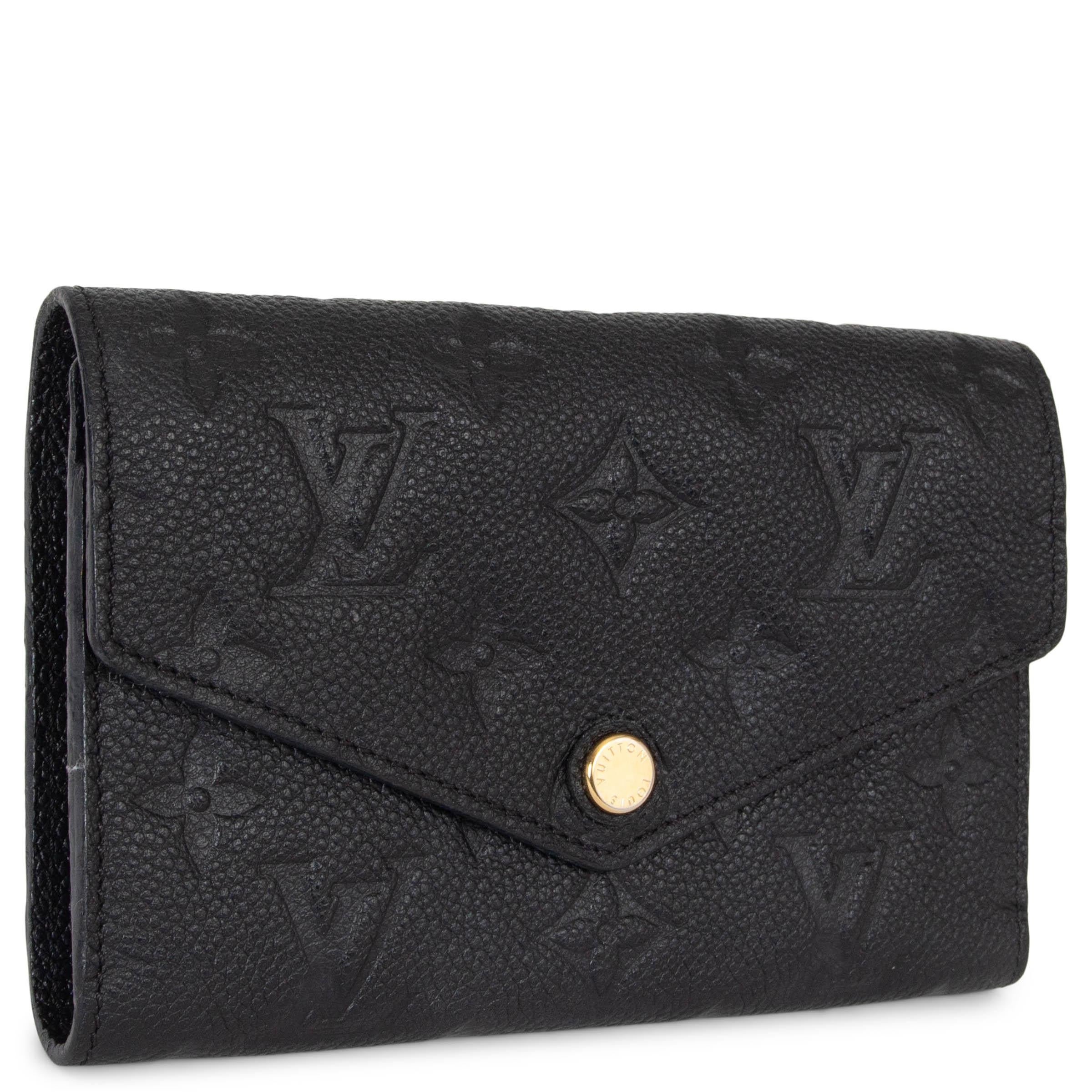 This 100% authentic Louis Vuitton Victorine wallet in black Monogram Empreinte leather offers a perfect balance of elegance and practicality. Designed in an envelope style, it closes securely with a snap-button and opens to a leather-lined interior.