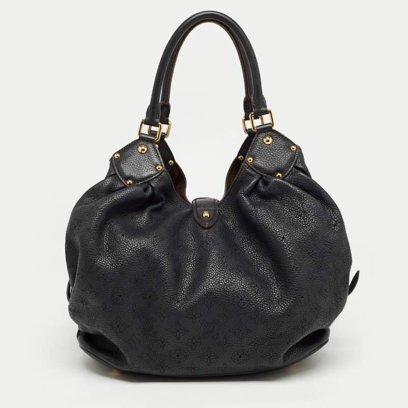This bag from the house of Louis Vuitton is a delight to own. Louis Vuitton's Mahina collection was inspired by the crescents of the moon. Featuring a slightly slouchy silhouette the bag comes with dual rolled top handles, buckle detailing on the