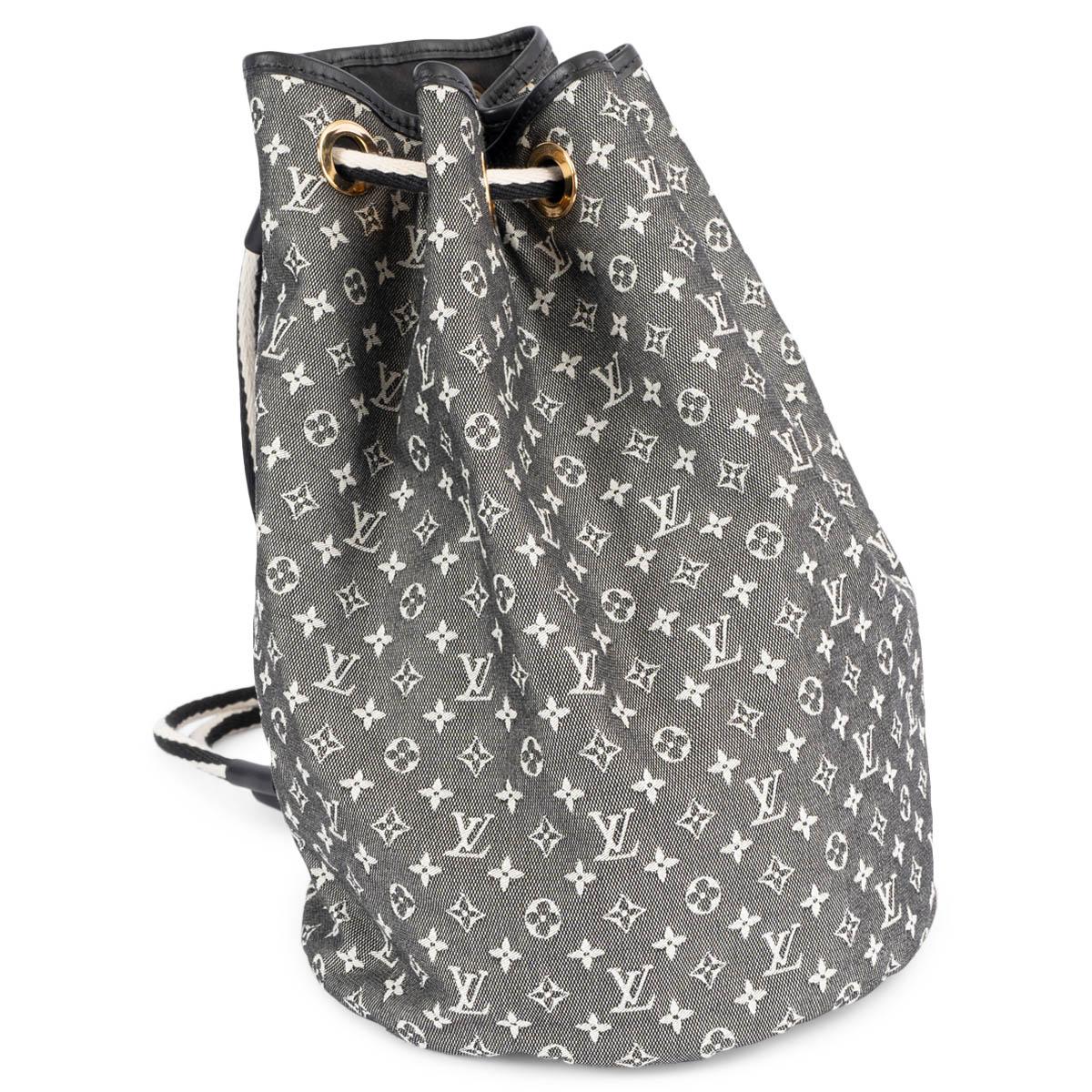 100% authentic Louis Vuitton Betsy in black & white Mini Lin monogram cotton canvas. The bag features black & white rope shoulder straps, cinch cords with black leather trim and golden tone hardware. The top is open to a roomy fabric interior in