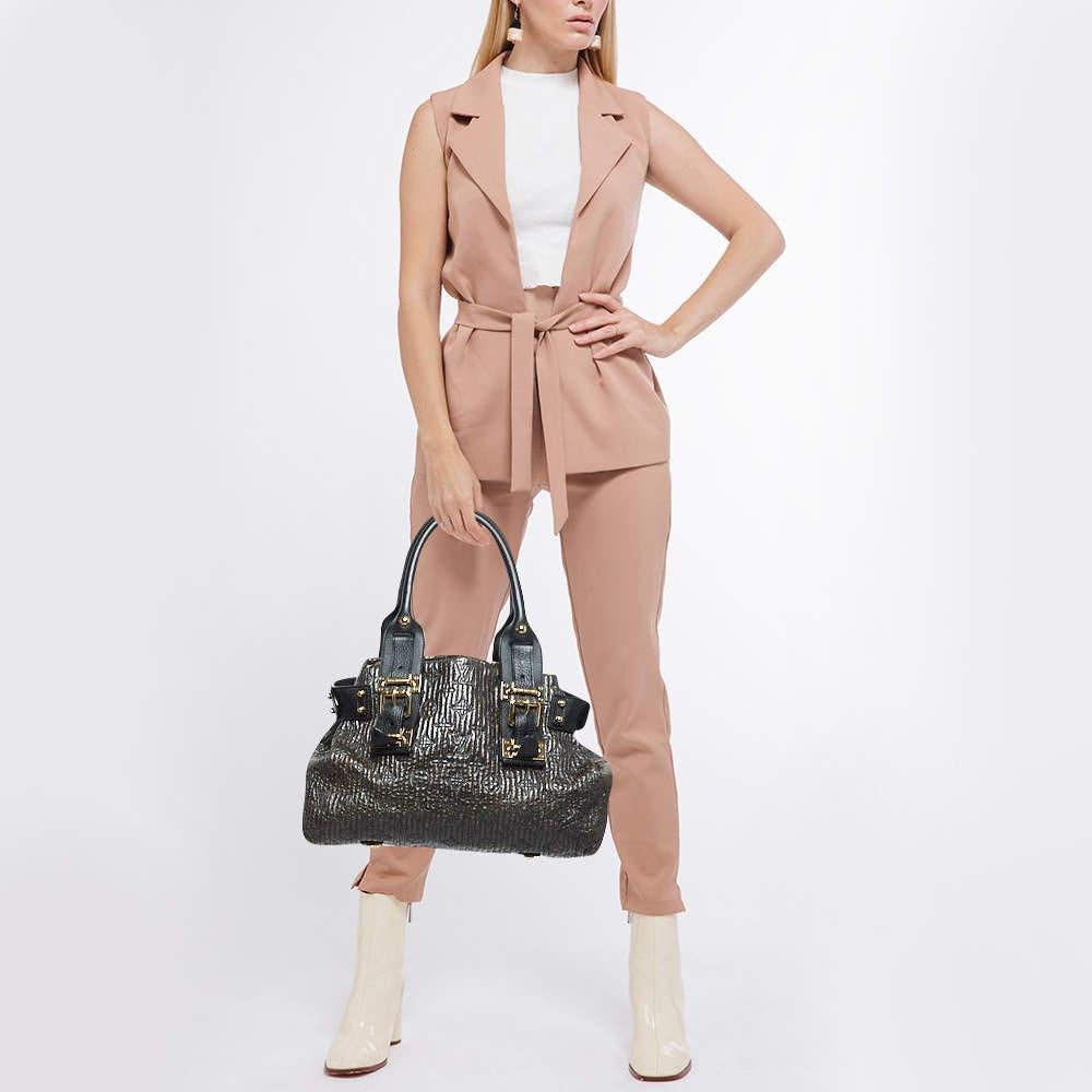 We are showering our love on this Motard Biker Bag from Louis Vuittons Fall/Winter 2007 Collection as it is limited and utterly gorgeous. The bag is crafted from black Monogram leather and features two handles coupled with gold tone hardware. It is