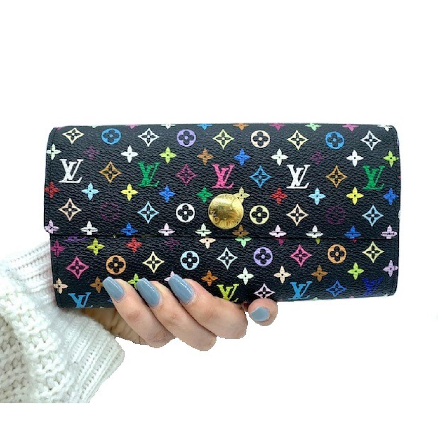 This Louis Vuitton Black Multicolore Monogram Canvas Sarah Wallet is the most elegant way to organize your essentials like your bills, currency, credit cards and plenty of coins. This delightful piece will always be a popular and timeless classic.