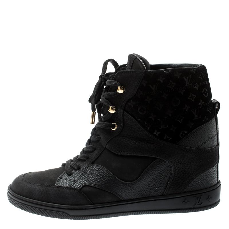 Don a cool, casual look with these black sneakers from the house of Louis Vuitton. They are crafted from suede and leather, where the top suede part is accented with monogram detailing. The shoes have lace-up fronts and the insoles are lined with
