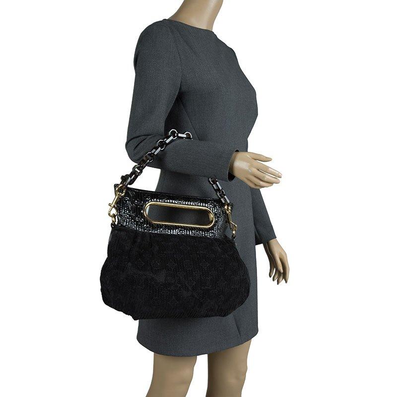 Part of the Limited Edition, this Louis Vuitton Afterdark bag features a black monogram motard suede body and leather detailed top with dual cut-out handles. The single slit pocket has just enough room to stow in your essentials like cell phone,