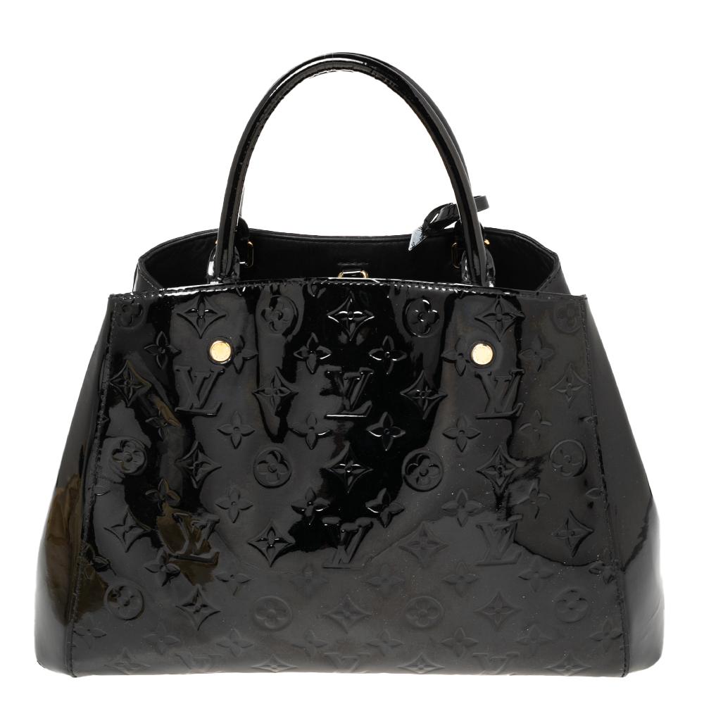A handbag should not only be good-looking but also functional, just like this Montaigne bag from Louis Vuitton. Crafted from Monogram Vernis leather, this gorgeous number has a clasp fastening that opens up to a spacious fabric interior. It features