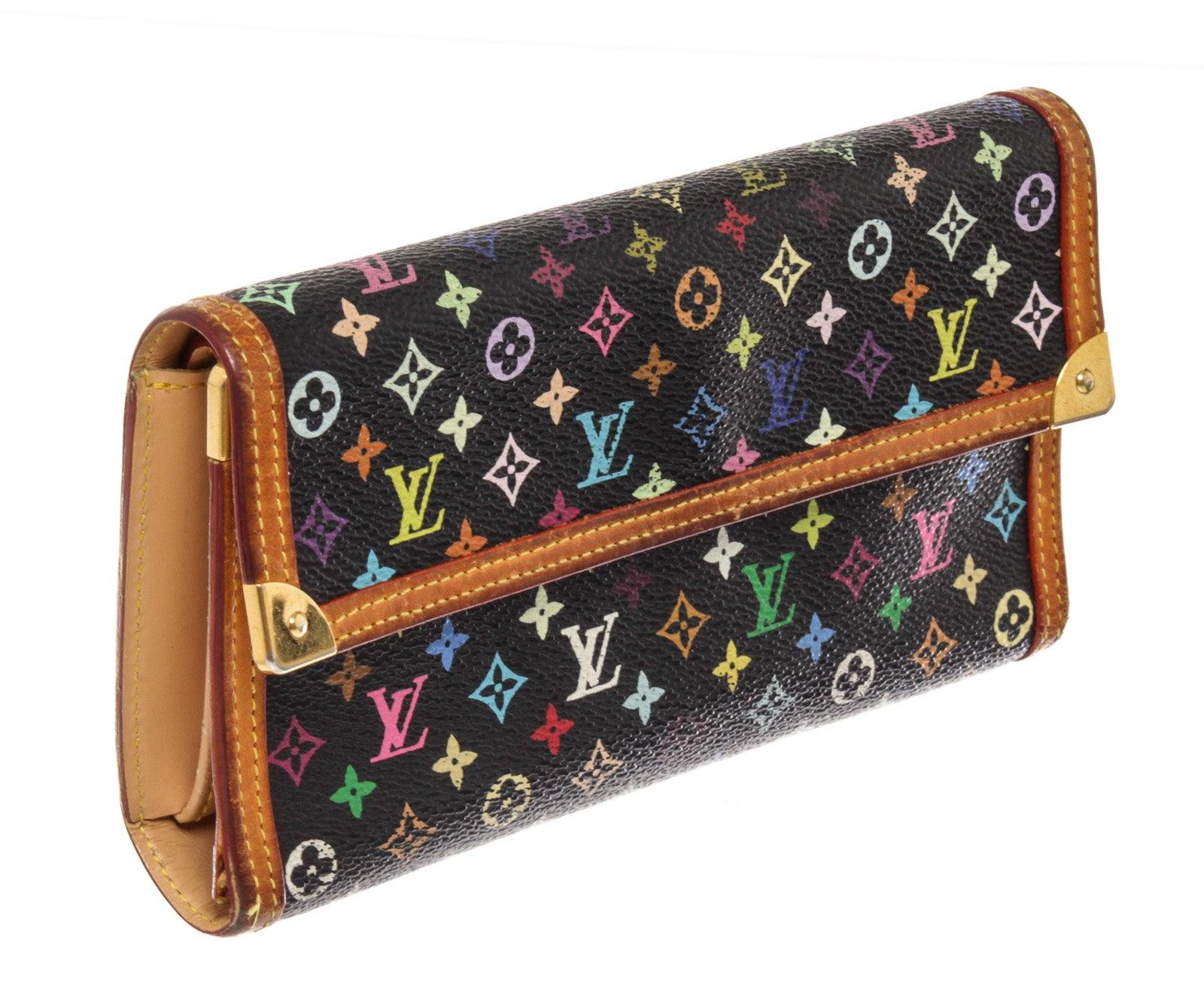 Black multicolor Monogram coated canvas Louis Vuitton International wallet with gold-tone hardware, beige leather lining, four card slots and dual bill compartments at interior walls, coin pouch with snap closure and snap closure at front flap.


