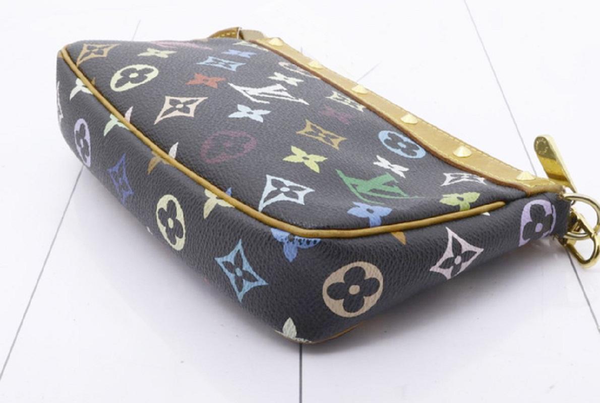 Black multicolor monogram coated canvas Louis Vuitton Pochette Accessoires shoulder bag with gold-tone hardware, tan leather trim, a flat shoulder strap, studded accents, brown Alcantara lining and zip closure at top.


71286MSC