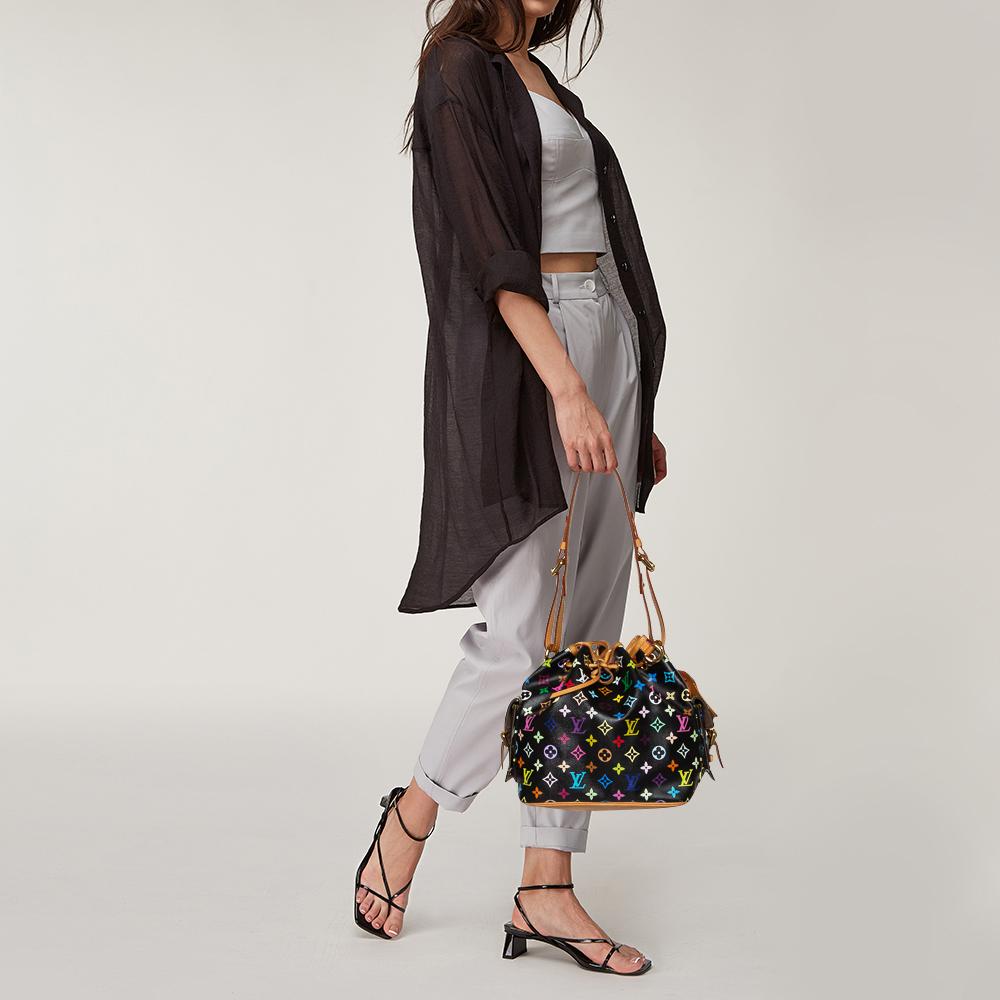 Created in 1932 by Louis Vuitton to carry bottles of Champagne, the iconic Noe now serves as a stylish daytime handbag. Crafted from Multicolor Monogram canvas and leather, the black bag exudes just the right amount of sophistication. It has a