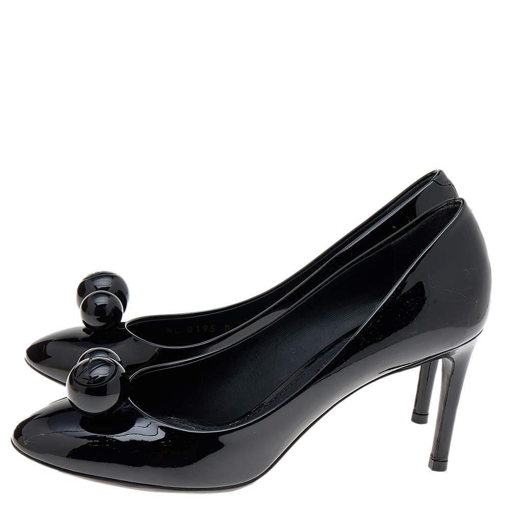 These lovely pumps from Louis Vuitton are an ideal choice as they are stylish and comfortable. They are made of black patent leather and designed with round embellishments on the vamps. This delicate pair is perfect for parties and work.

