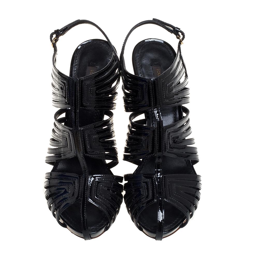 Stay casual and keep your feet pretty in these sandals from Louis Vuitton. These patent leather sandals can give other footwear a run for their money. Lined with leather, these caged sandals are tailored to offer you maximum comfort & style. They