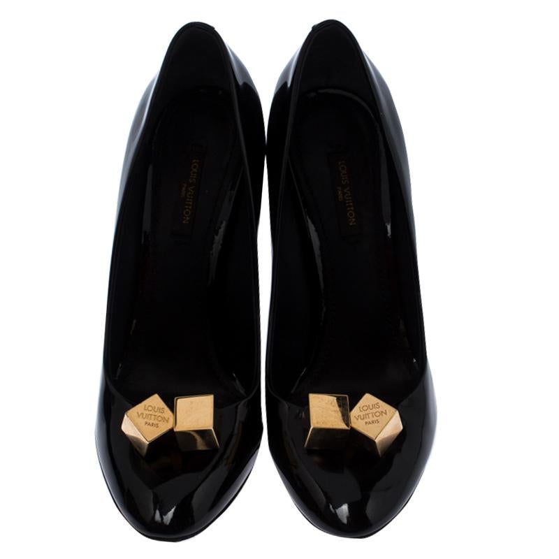 Personify elegance while flaunting these patent leather pumps. They are from Louis Vuitton and they feature almond toes, LV metal cubes on the uppers and 11 cm high stiletto heels. In an impressive shade of black, these pumps are a perfect fit for a