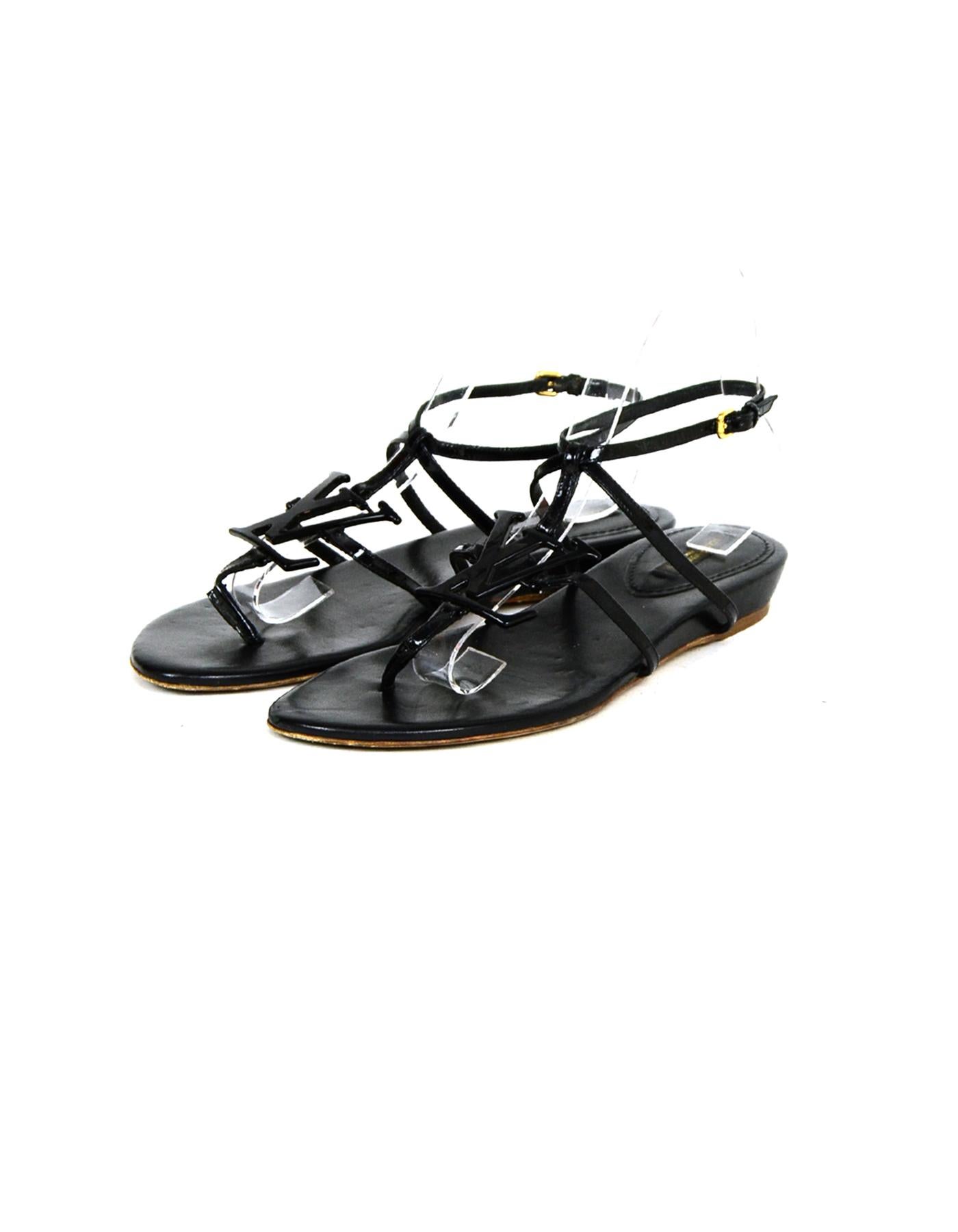 Louis Vuitton Black Patent Leather Flat Sandal w/ Resin LV

Made In: Italy
Color: Black
Hardware: Goldtone
Materials: Patent leather straps, Resin LV, Leather insole.
Closure/Opening: Side buckle
Overall Condition: Very good pre-owned condition,