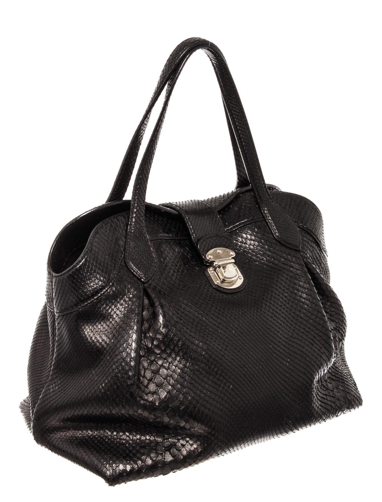 Louis Vuitton Cirrus MM Shoulder Bag is made of the finest black Python leather. This doctor frame bag features silver-tone hardware, one zip side pocket, four protective stud accents, a top buckle and press lock closure. Its press-lock closure