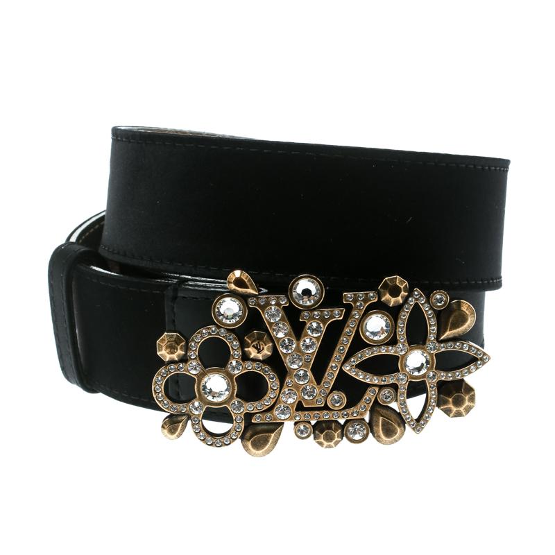 This gorgeous Runway belt from Louis Vuitton will lend an extra character to your chic, statement dresses. This belt, crafted from satin and leather trims, features a beautiful rhinestones-encrusted gold LV monogram buckle. The buckle is surrounded