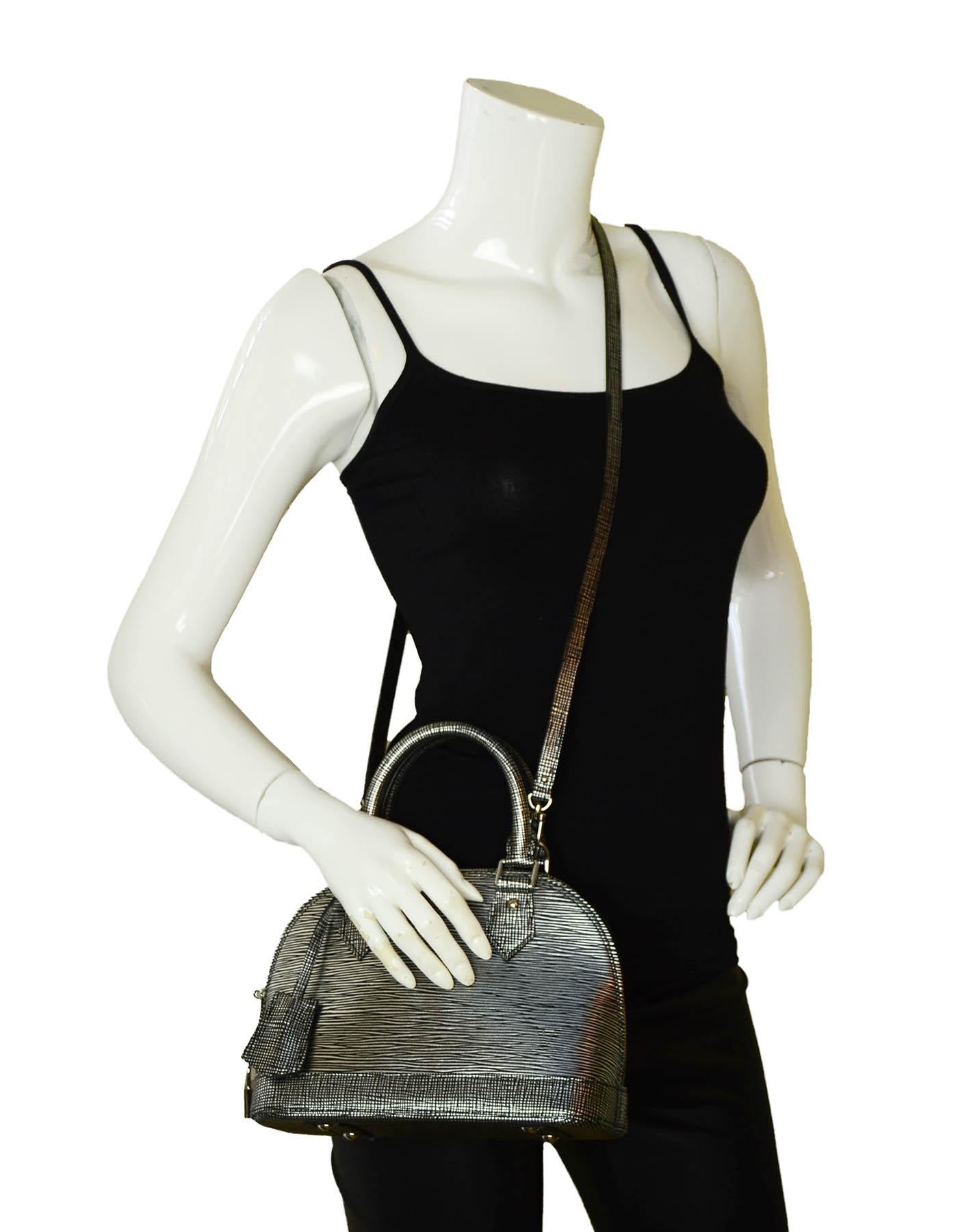 Louis Vuitton Black & Silver Epi Leather Alma BB Top Handle Crossbody Bag

Made In: France
Color: Silver and black
Hardware: Silvertone
Materials: Epi leather
Lining: Black alcantara 
Closure/Opening: Two-way zip top
Interior Pockets: One
