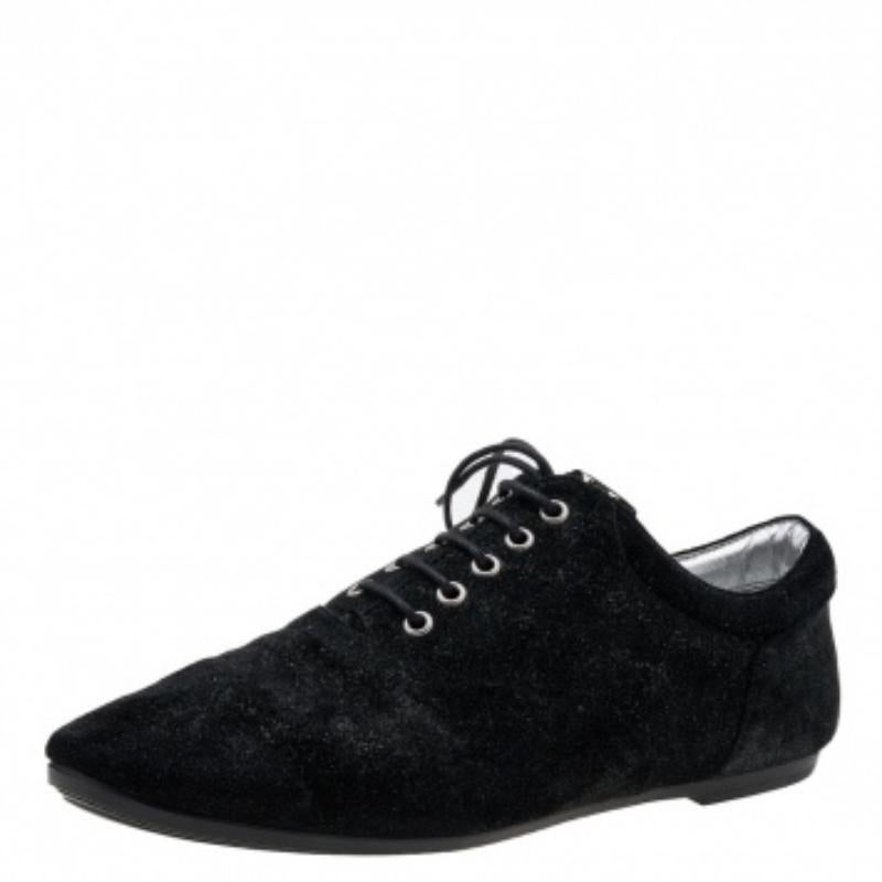 Chic and super comfortable, this pair of oxfords by Louis Vuitton will make a great addition to your shoe collection. They've been crafted from black and silver glitter suede and styled with neatly-placed lace-ups. Tough rubber soles finely complete