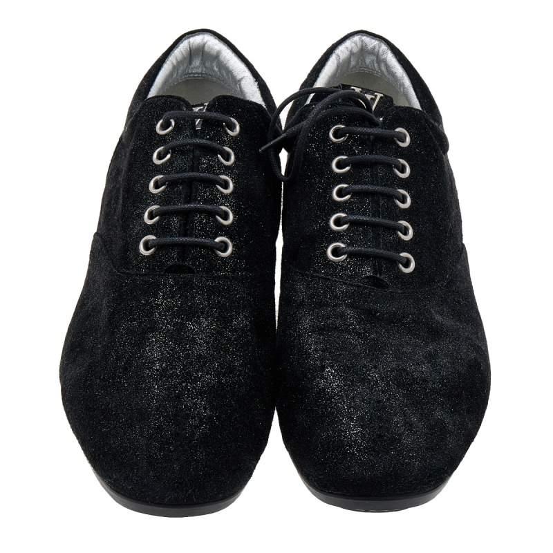Chic and super comfortable, this pair of oxfords by Louis Vuitton will make a great addition to your shoe collection. They've been crafted from black and silver glitter suede and styled with neatly-placed lace-ups. Tough rubber soles finely complete