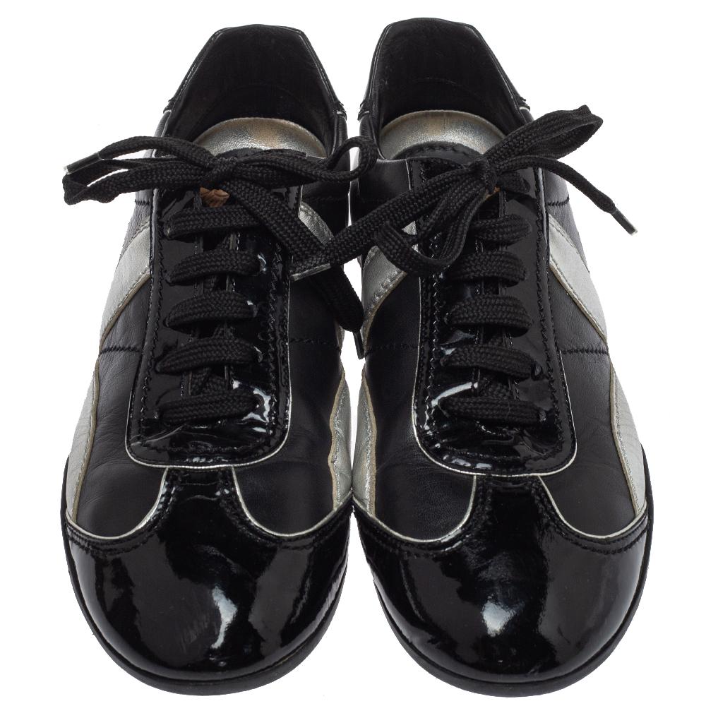 Ace the sneaker game in these fabulous sneakers from Louis Vuitton! These black & silver sneakers are crafted from leather and patent leather trims and feature round toes and lace-ups on the vamps. They come equipped with comfortable leather-lined