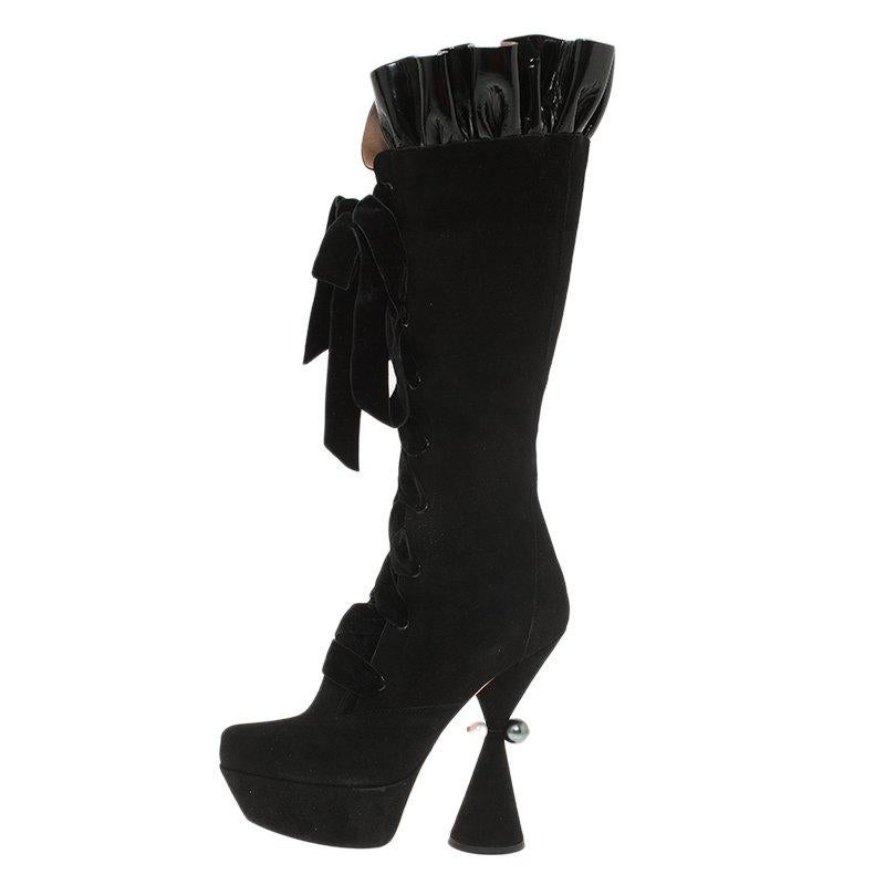 This pair of Cancan lace up knee boots coming from Louis Vuitton will offer a captivating and cool look to your personality. It is crafted from black suede and is adorned with stunning velvet lace up design, and an adorable ruffled top with patent