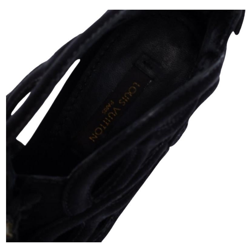 Louis Vuitton's monogram comes alive in this pair of ankle boots in an exciting fashion. With notable cutout design, this black pair is high on style and signature elements. The pair is rendered in suede and is furnished with open toes, lace-ups on