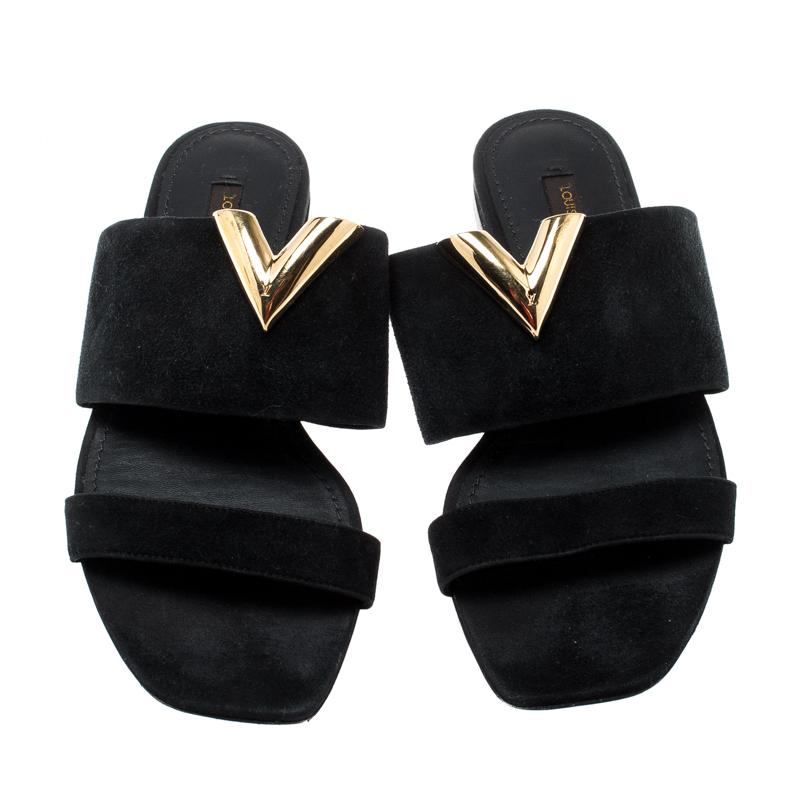 This Louis Vuitton pair is designed in such a way to offer you both comfort and style. These black sandals are designed with two suede straps and detailed with a V motif in gold-tone metal. Lined with leather and high on appeal, this pair is a