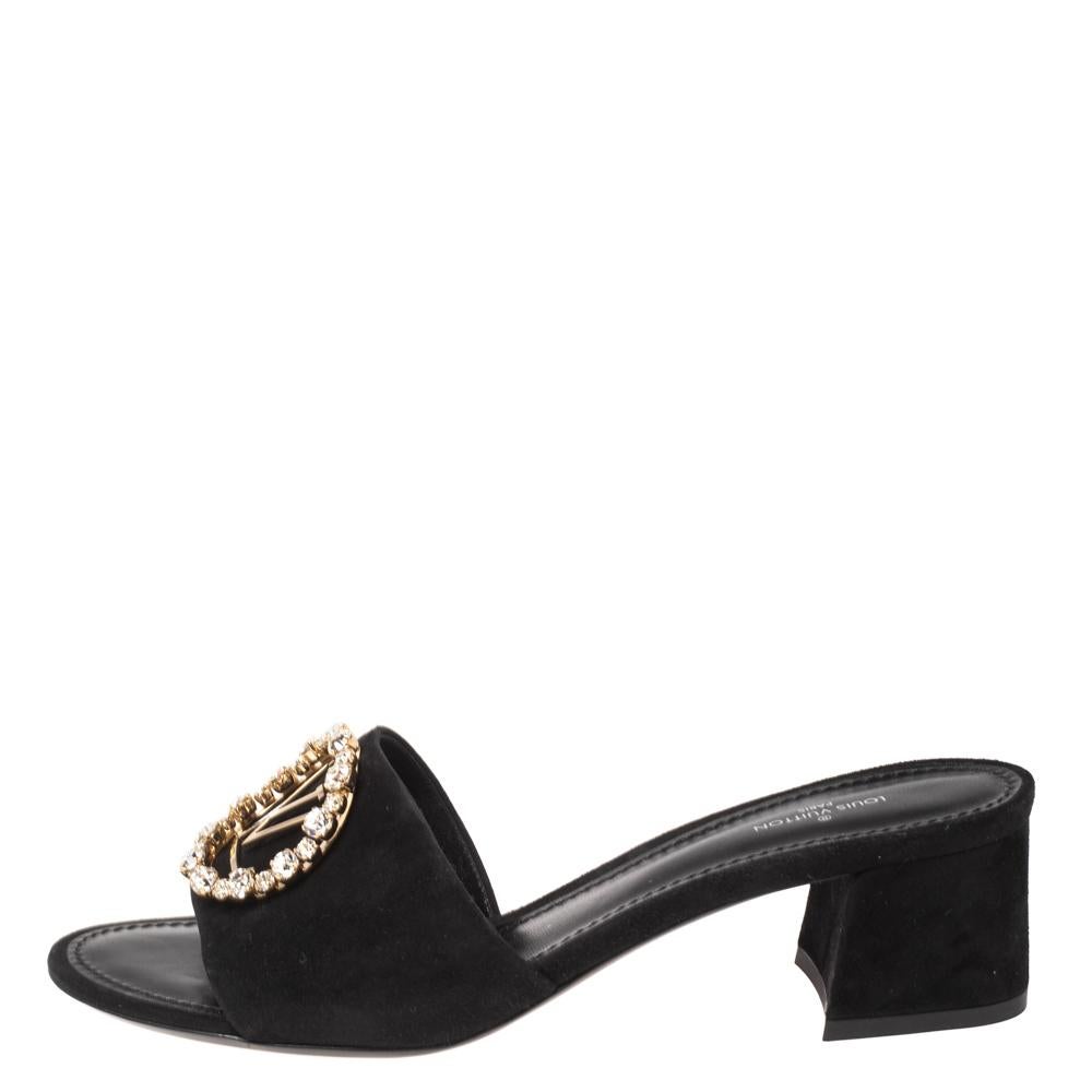 Louis Vuitton's Madeleine sandals exude a refined style and sophisticated vibe with their minimal design. Crafted from black suede leather, they feature the LV logo on the front and open toes. These beauties are finished off with block heels and