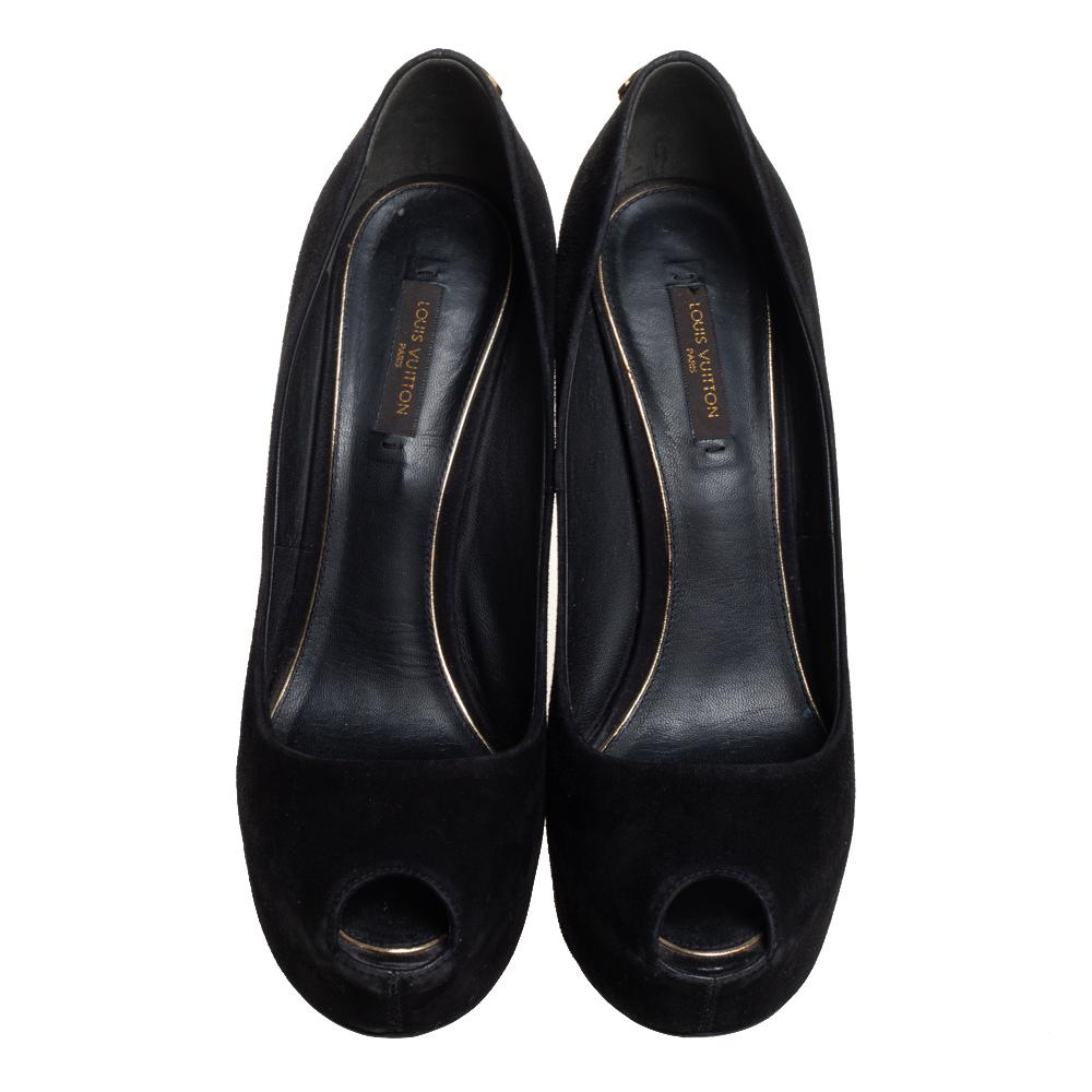 Sleek in black, these pumps from Louis Vuitton come crafted from suede into a peep-toe silhouette. The pumps are equipped with comfortable leather-lined insoles, platforms, and 14 cm heels. They are highlighted with gold-tone padlock accents on the