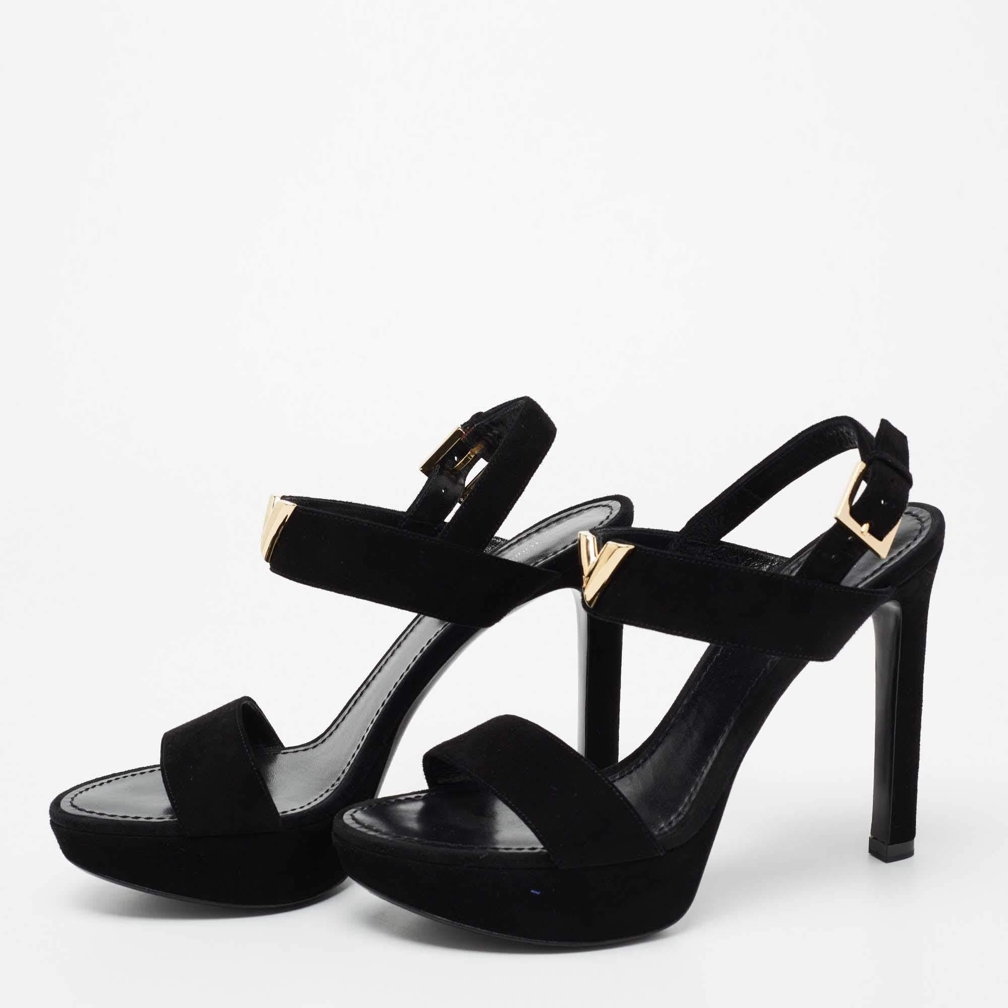 Beautifully designed and lovely to look at, this pair of sandals by Louis Vuitton is a keeper. They carry a suede exterior, buckle fastenings, and 11.5 cm heels supported by platforms. The black sandals are accented by gold-tone hardware detailing