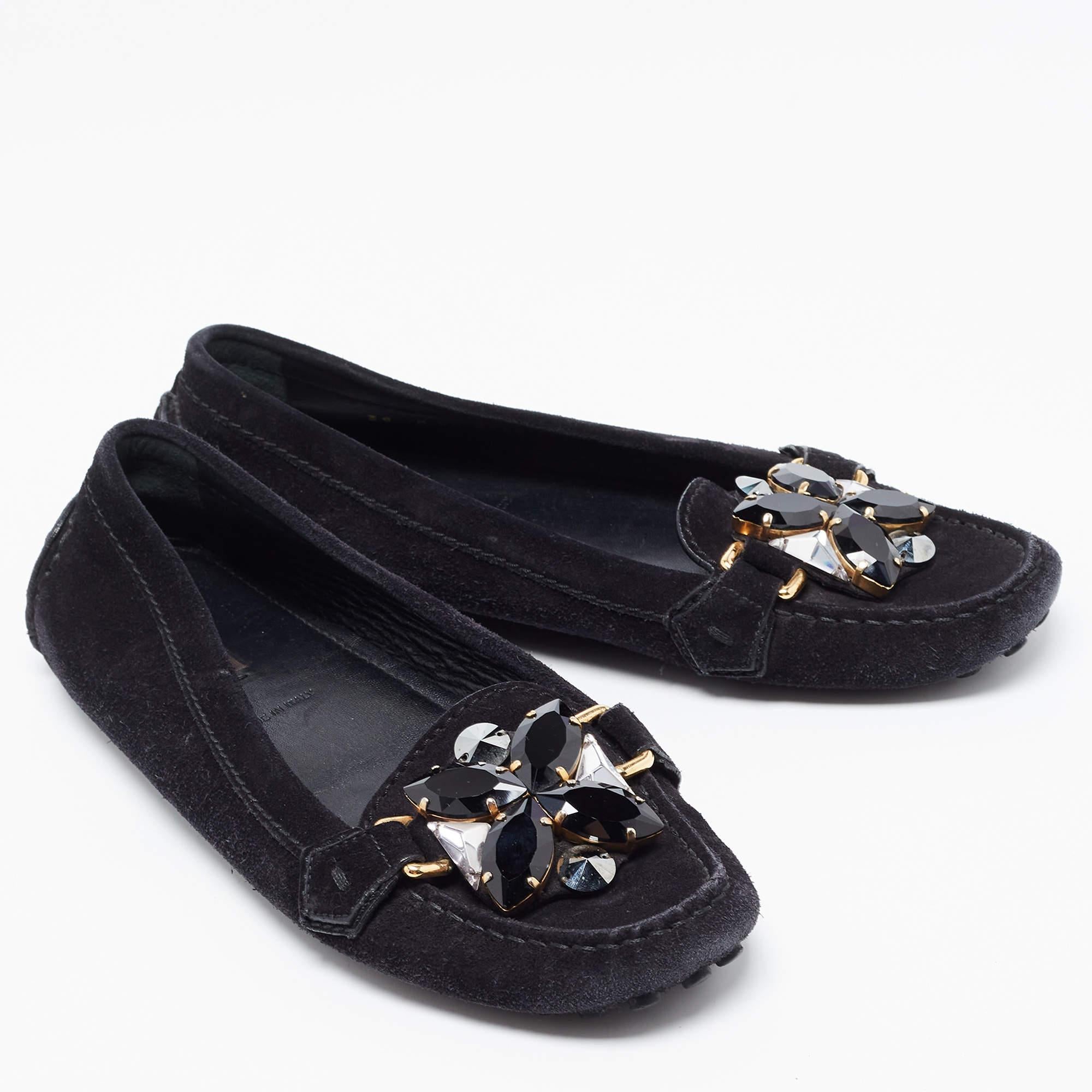 Crafted from suede and styled into an edgy shape, this pair of black loafers by Louis Vuitton is a blend of luxury and comfort. They feature gorgeous crystal embellishments on the front, leather lined insoles and rubber pebbling on the outsoles. The