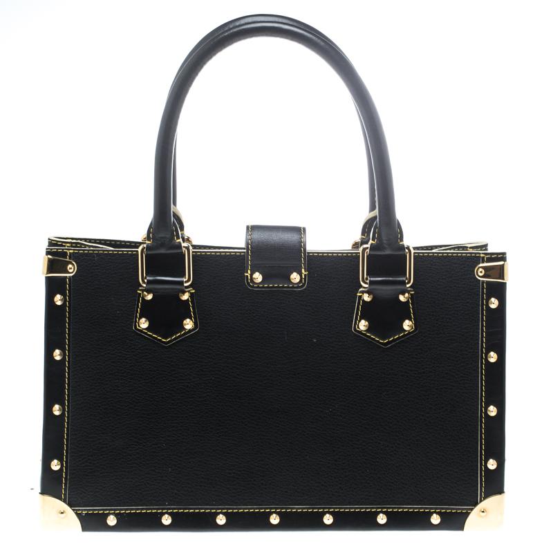 Louis Vuitton's Le Fabuleux bag looks nothing like a regular Louis Vuitton bag! Rectangular in shape the bag is crafted from black suhali leather and has stud embellishments. It features dual top handles, a front zip pocket, and a S lock closure.