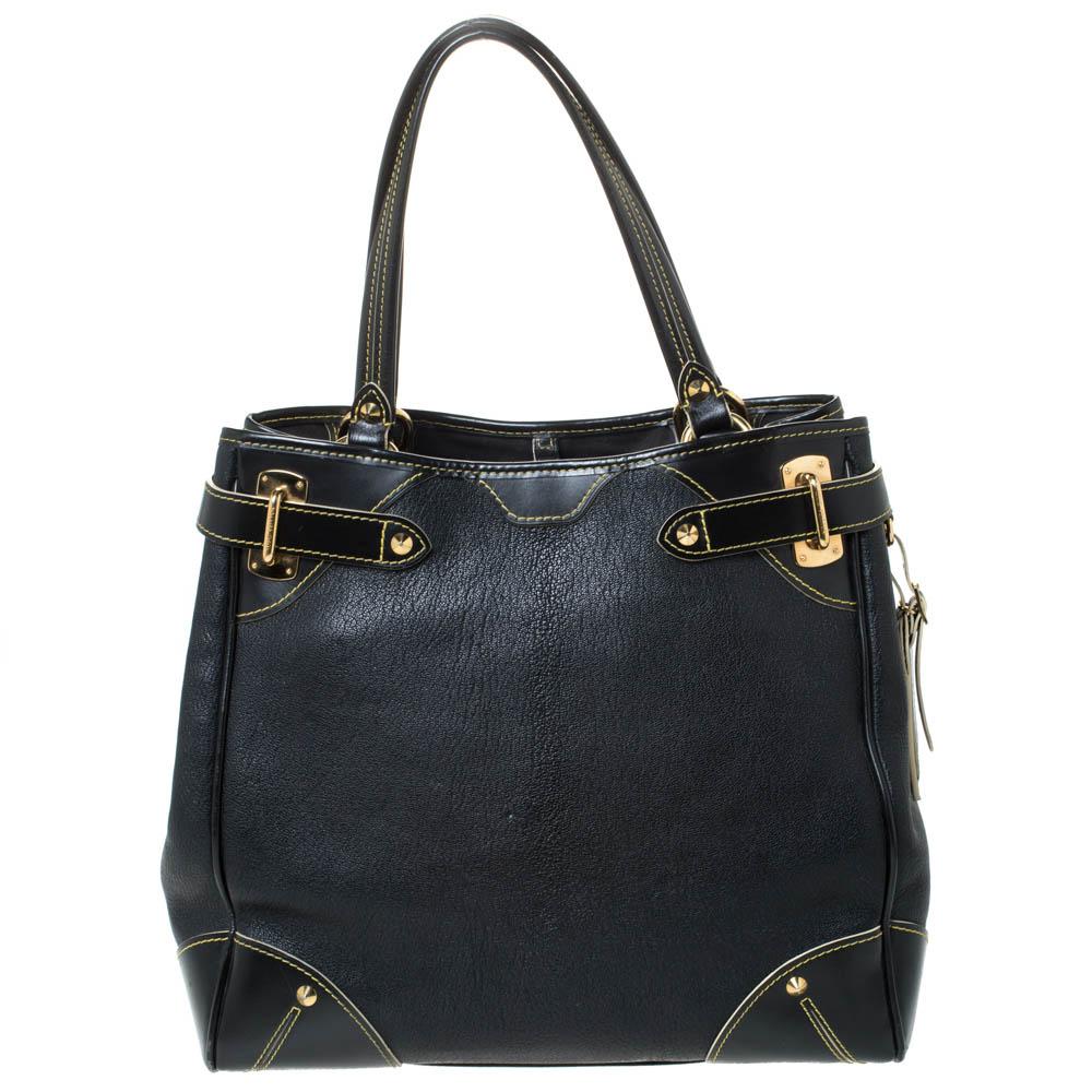 Sleek and chic, this LV tote in classic black is part of the Suhali collection. Made from quality leather, this bag is accented with smooth leather accents at the corners, a leather ID tag and gold-tone buckled straps. This practical bag has two