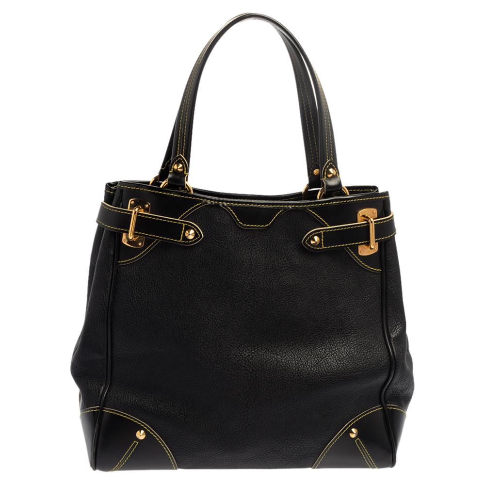 Sleek and chic, this LV bag in classic black is part of the Suhali collection. Made from quality leather, this bag is accented with smooth leather accents at the corners and gold-tone buckled straps. This practical bag has two flat handles and is