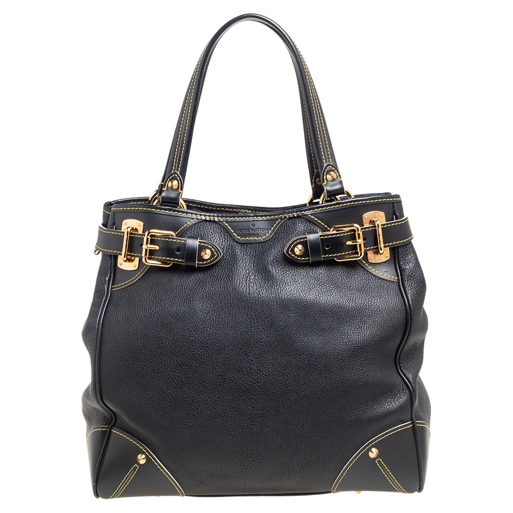 Sleek and chic, this LV tote in a classic black shade is part of the Le Majestueux collection. Made from Suhali leather, this bag is accented with buckle motifs, an LV tag, and gold-tone hardware. It is complete with two handles and a spacious