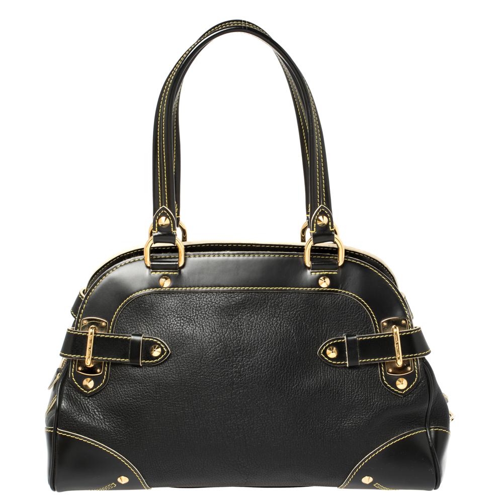 This Le Radieux bag from Louis Vuitton is gorgeous. The black beauty is crafted from leather and flaunts a unique and distinctive style. It features beautiful gold-tone studs, buckles, rings, and the lock accent all of which shine to make it an